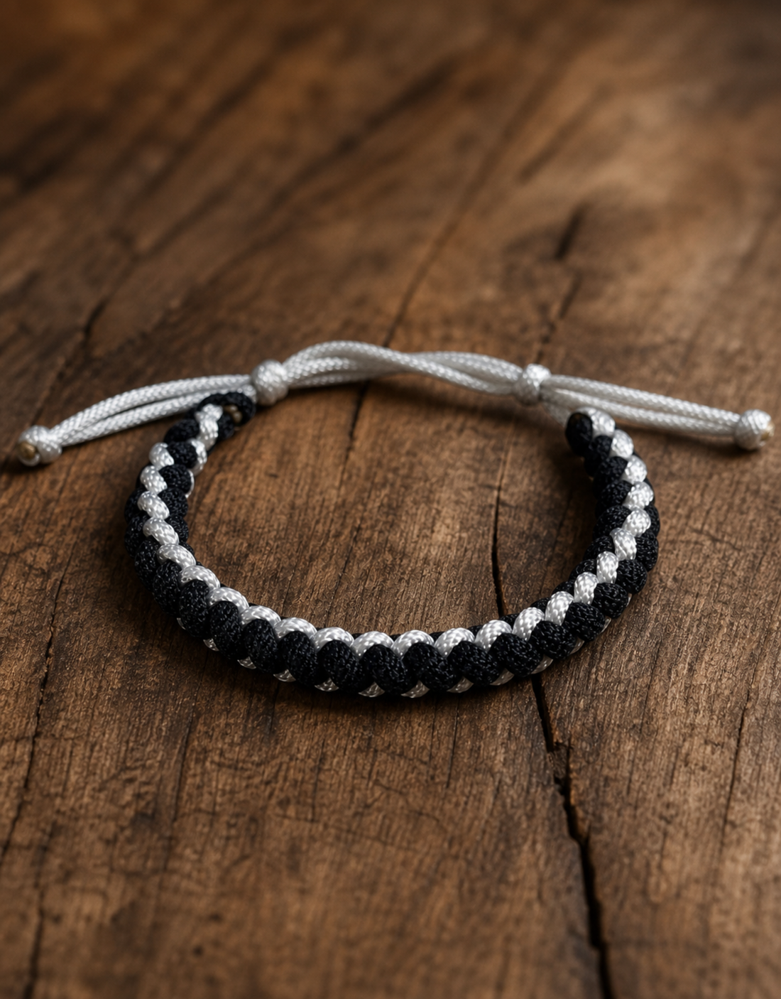 Black and white macrame bracelet on dark wood, a popular matching couple bracelet