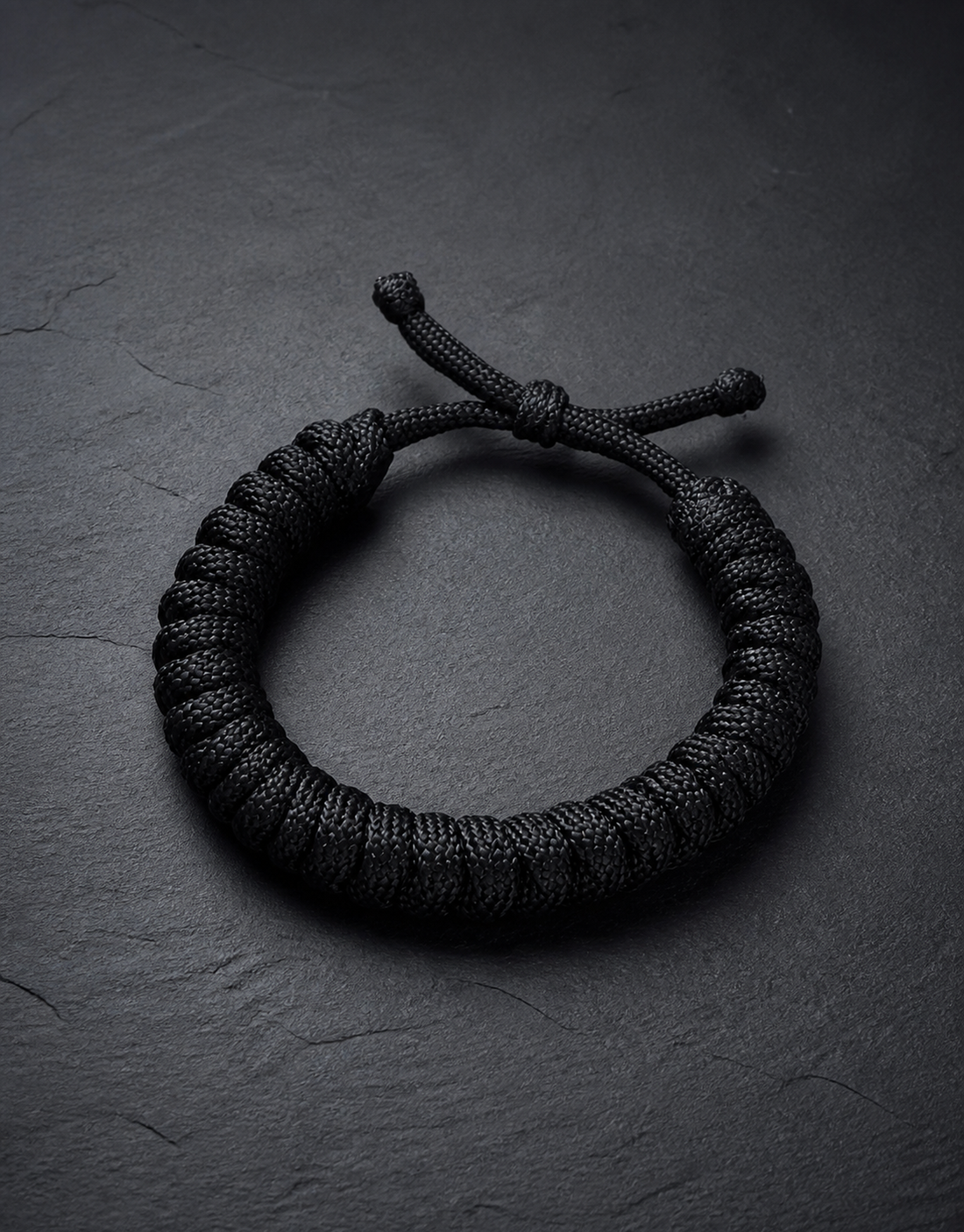 Black paracord bracelet in a flat lay