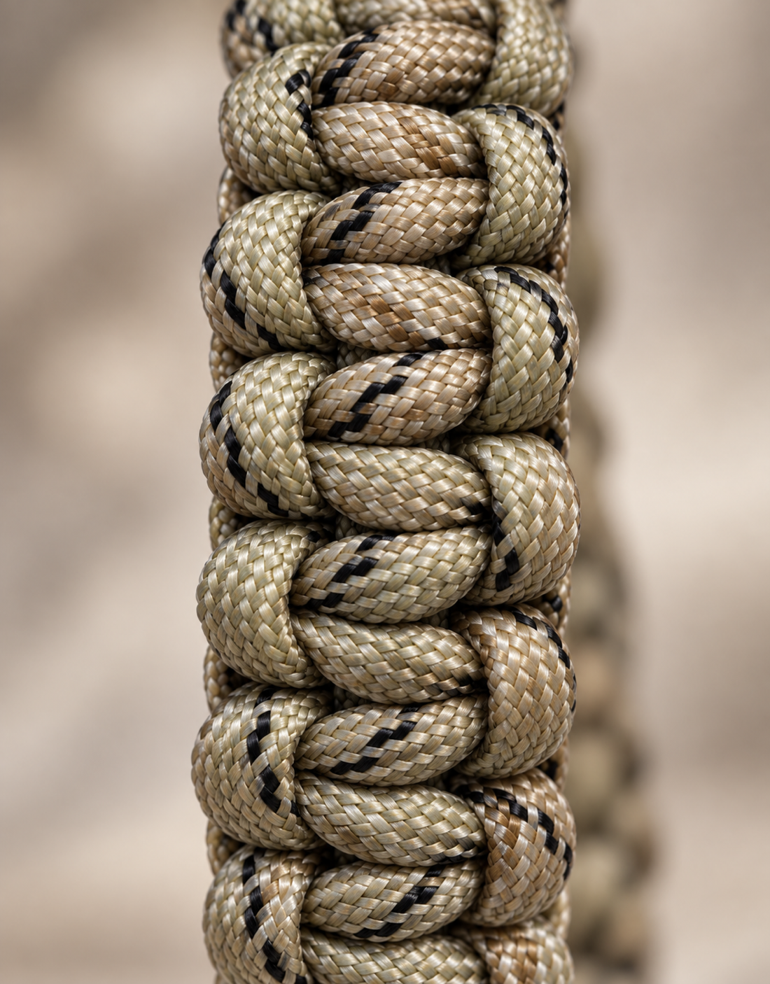 Close-up of a cobra weave paracord bracelet showing the knot pattern