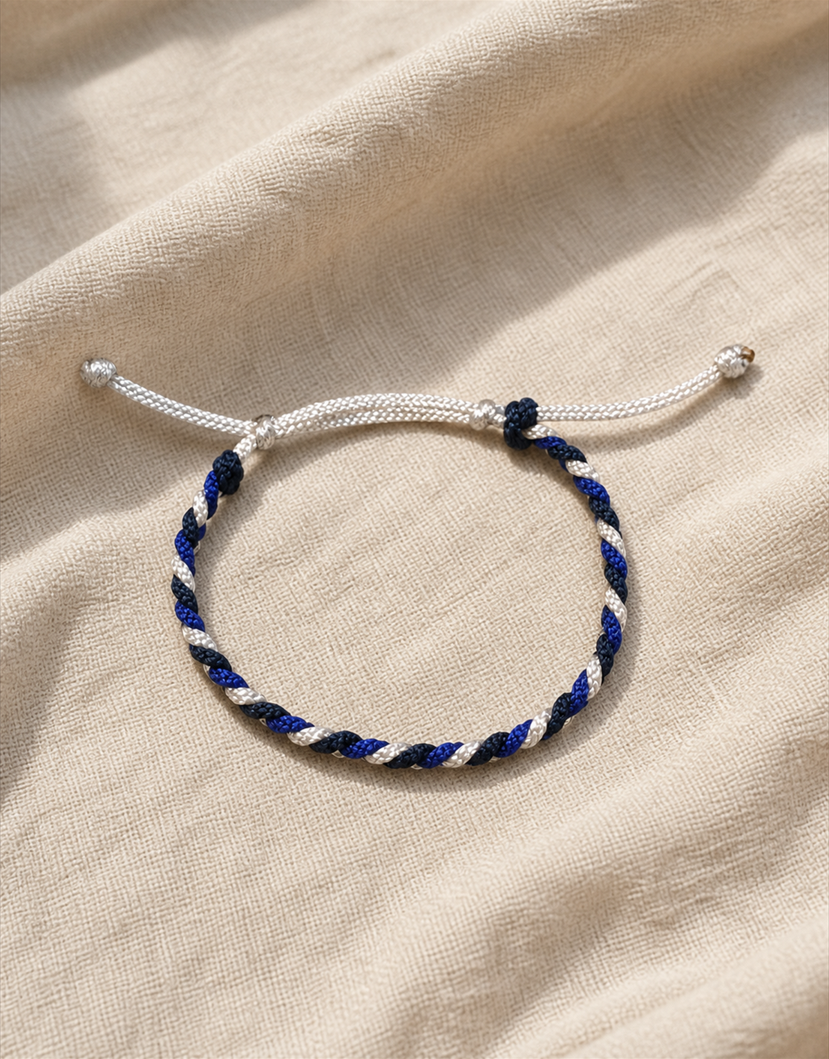 Sadeem twist bracelet on beige linen