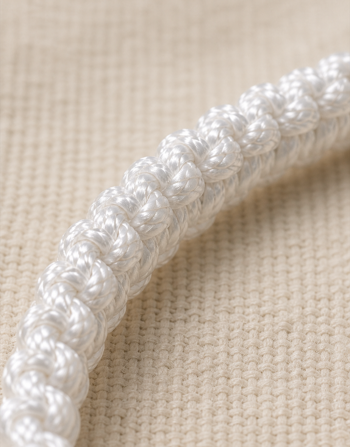 Close-up of the white macrame weave on the Durr bracelet