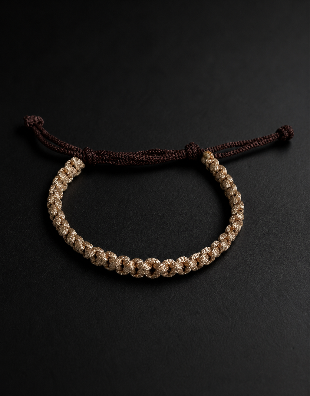 Qamhi tan and brown macrame bracelet on a black background