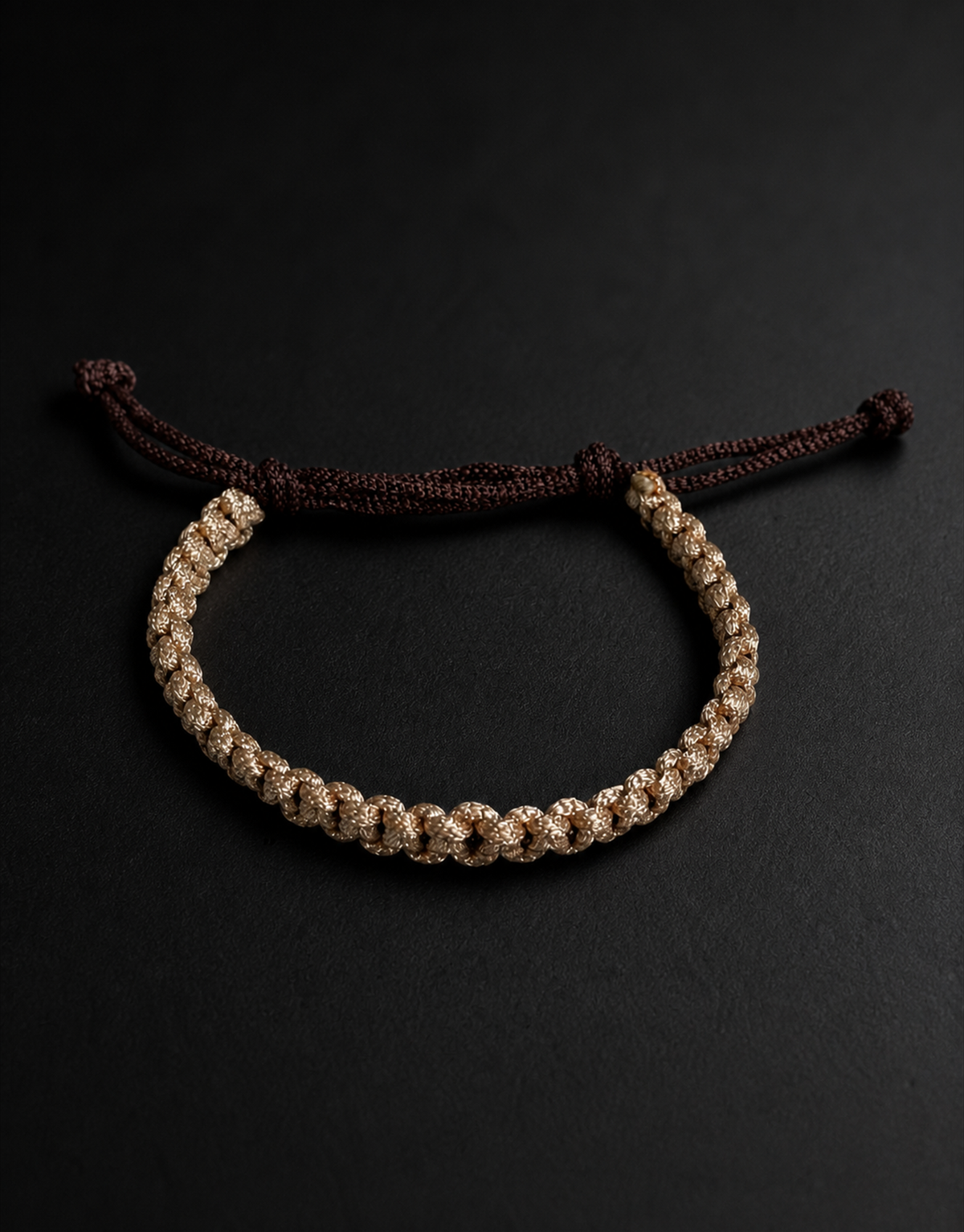 Qamhi tan and brown macrame bracelet on a black background