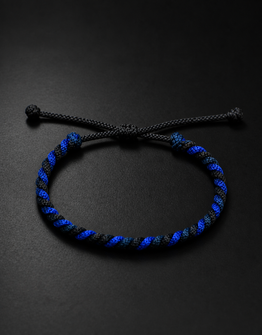 Neelam blue and black twist bracelet on a black background