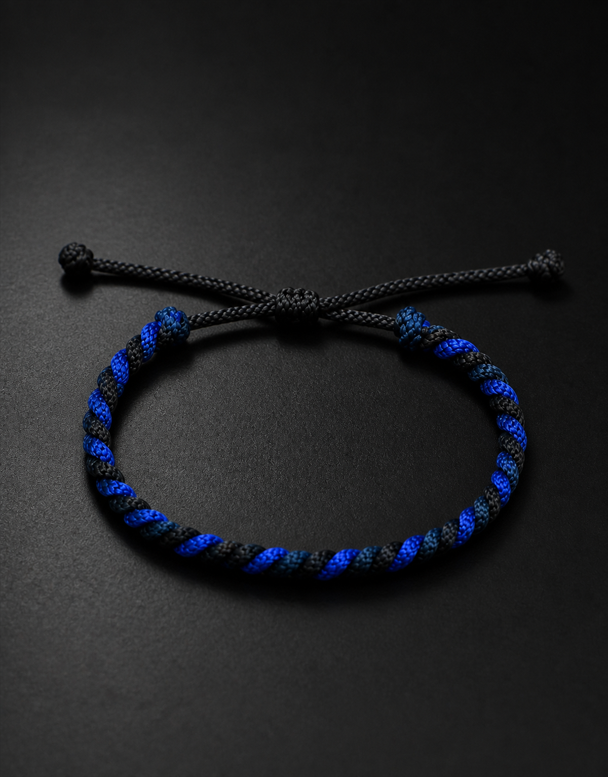 Neelam blue and black twist bracelet on a black background