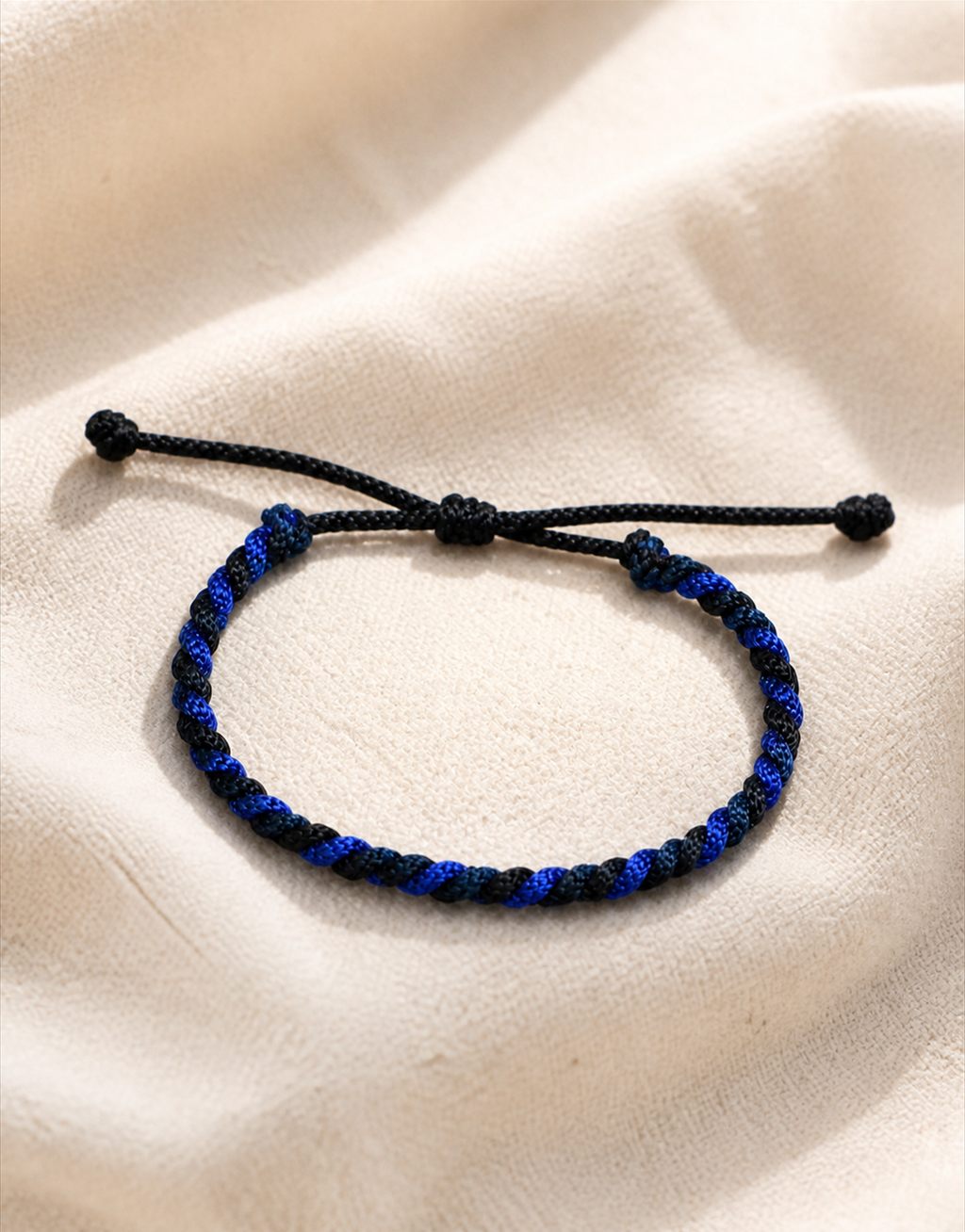 Neelam blue and black macrame bracelet on cream linen