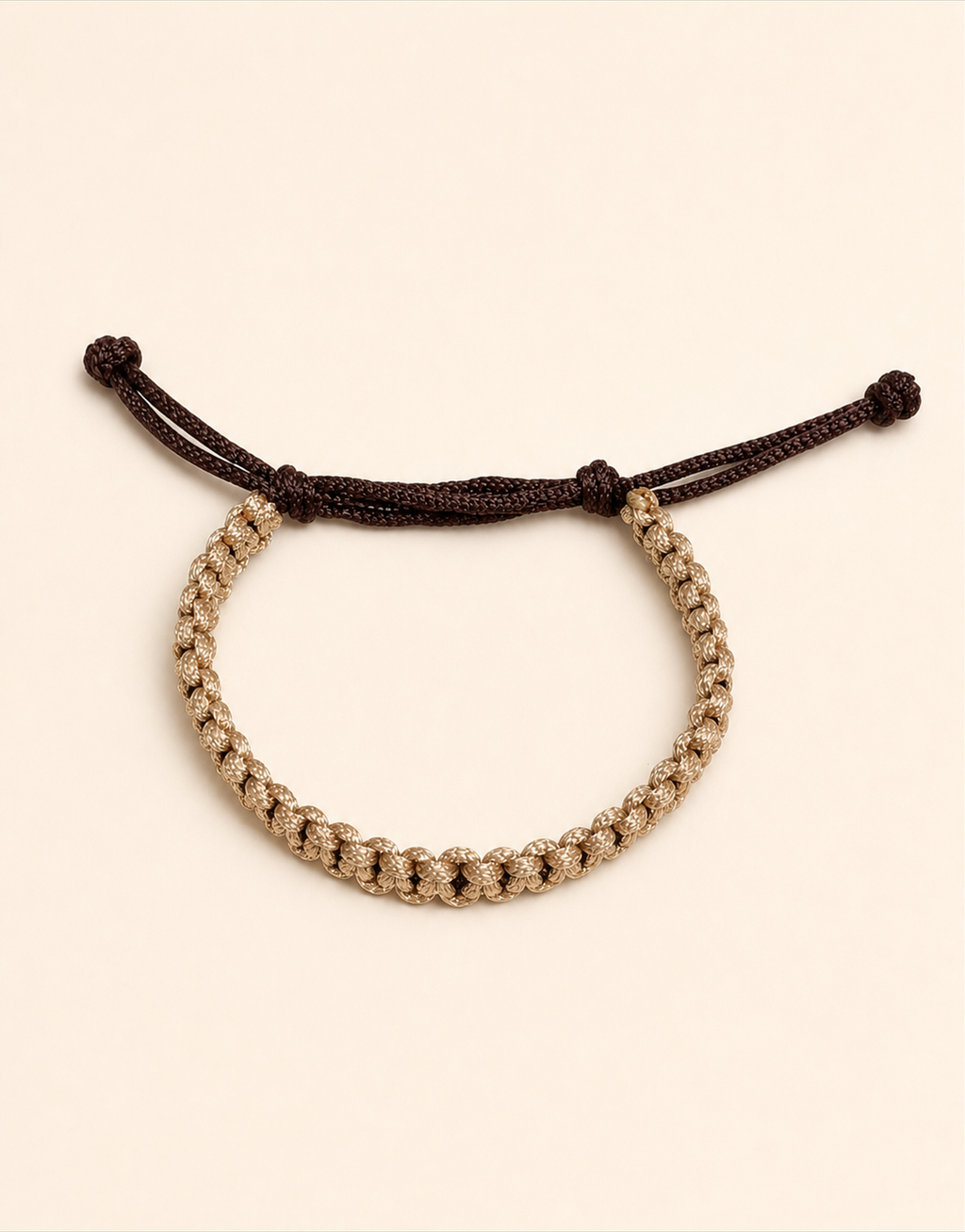 Qamhi tan macrame bracelet on a cream background