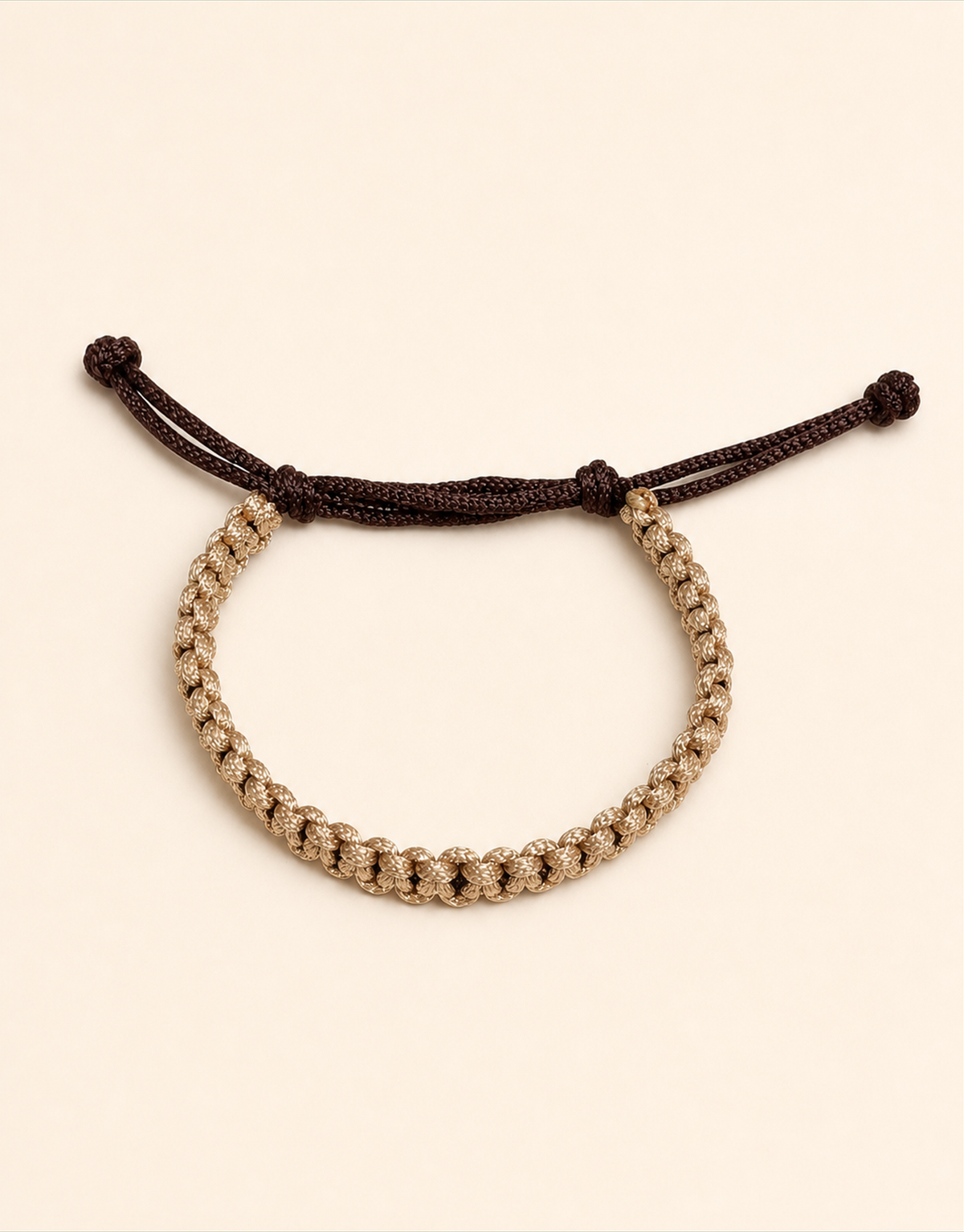 Qamhi tan macrame bracelet on a cream background