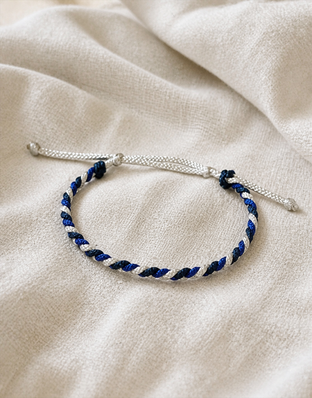 Sadeem blue, white and black macrame bracelet on linen