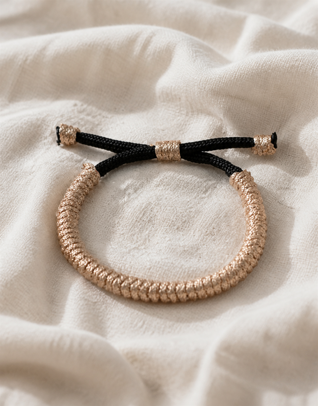 Kathib tan spiral macrame bracelet on cream fabric