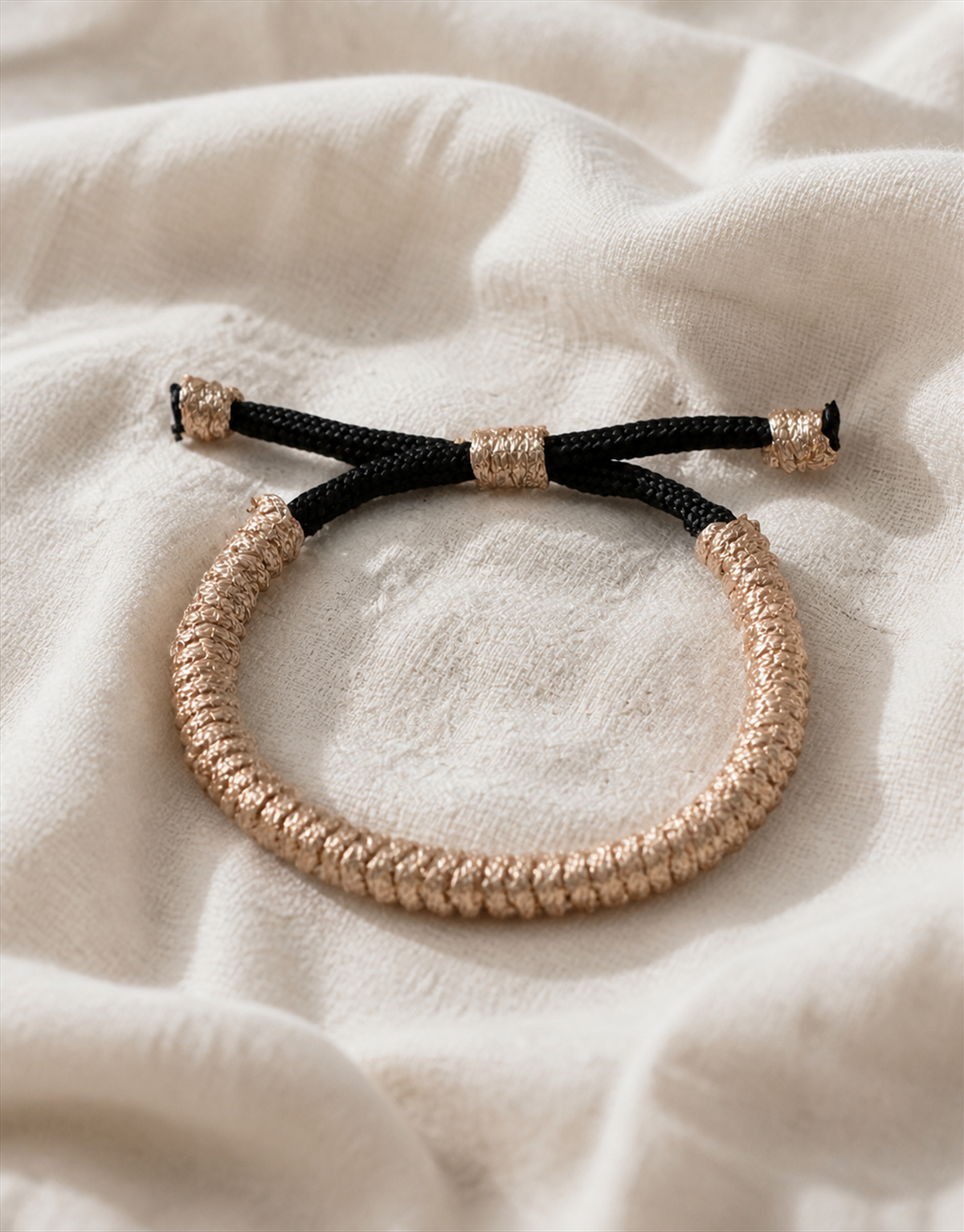 Kathib tan spiral macrame bracelet on cream fabric