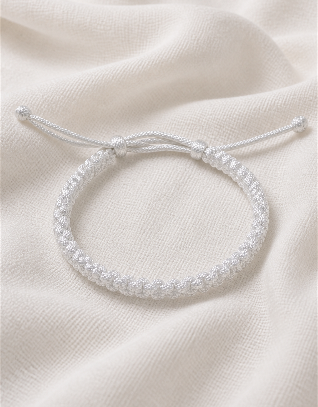 Durr white macrame bracelet on white fabric