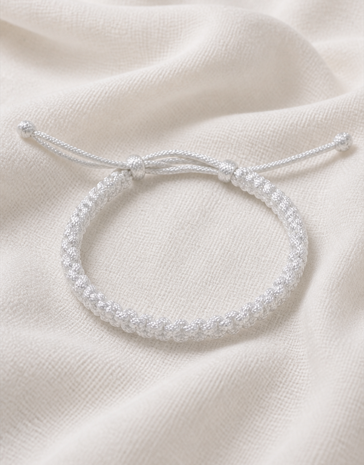 Durr white macrame bracelet on white fabric
