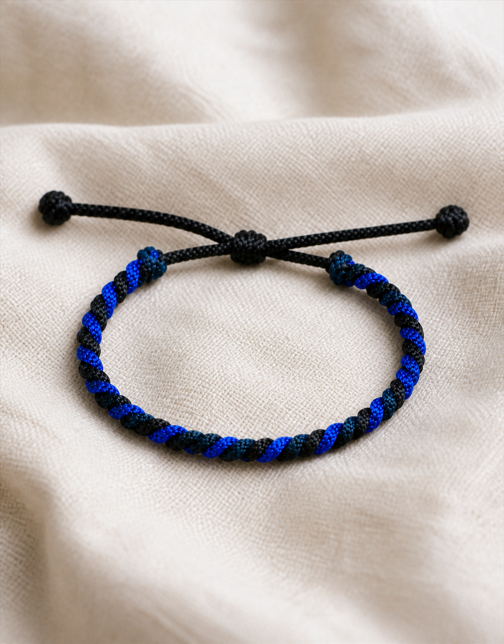 Neelam blue and black macrame bracelet on linen