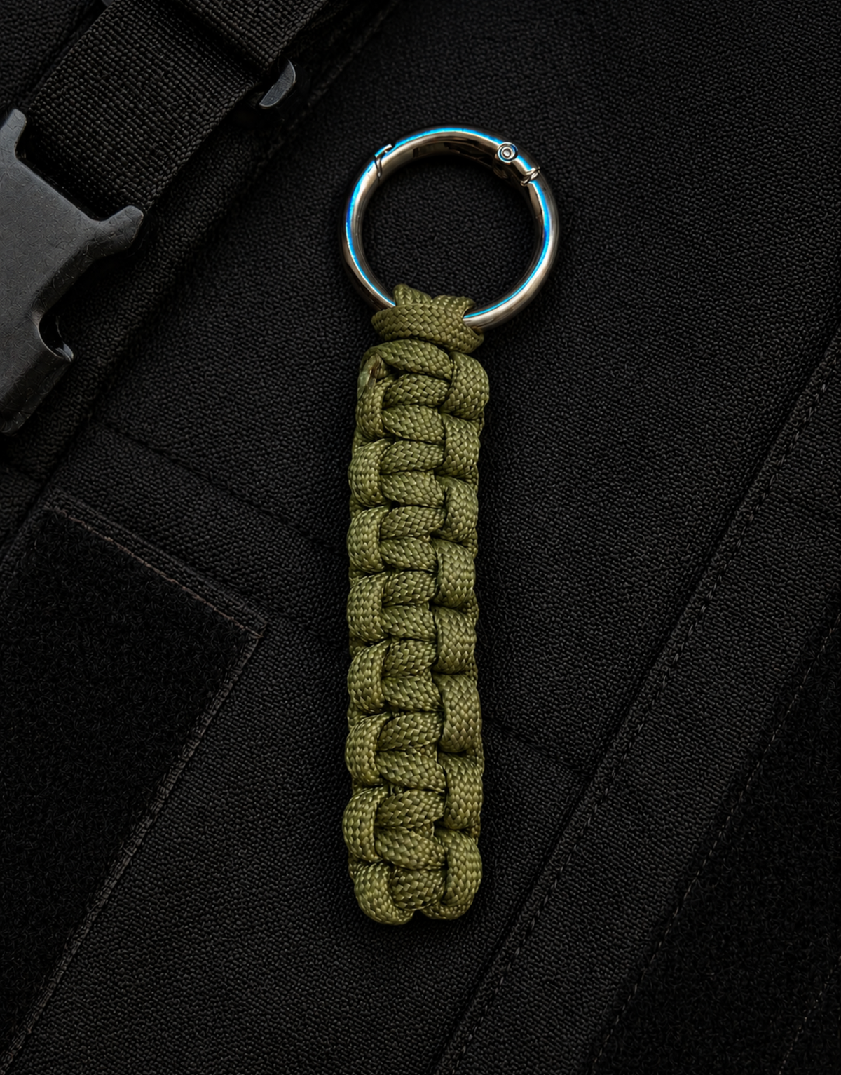 Naag olive paracord keychain on a black tactical bag
