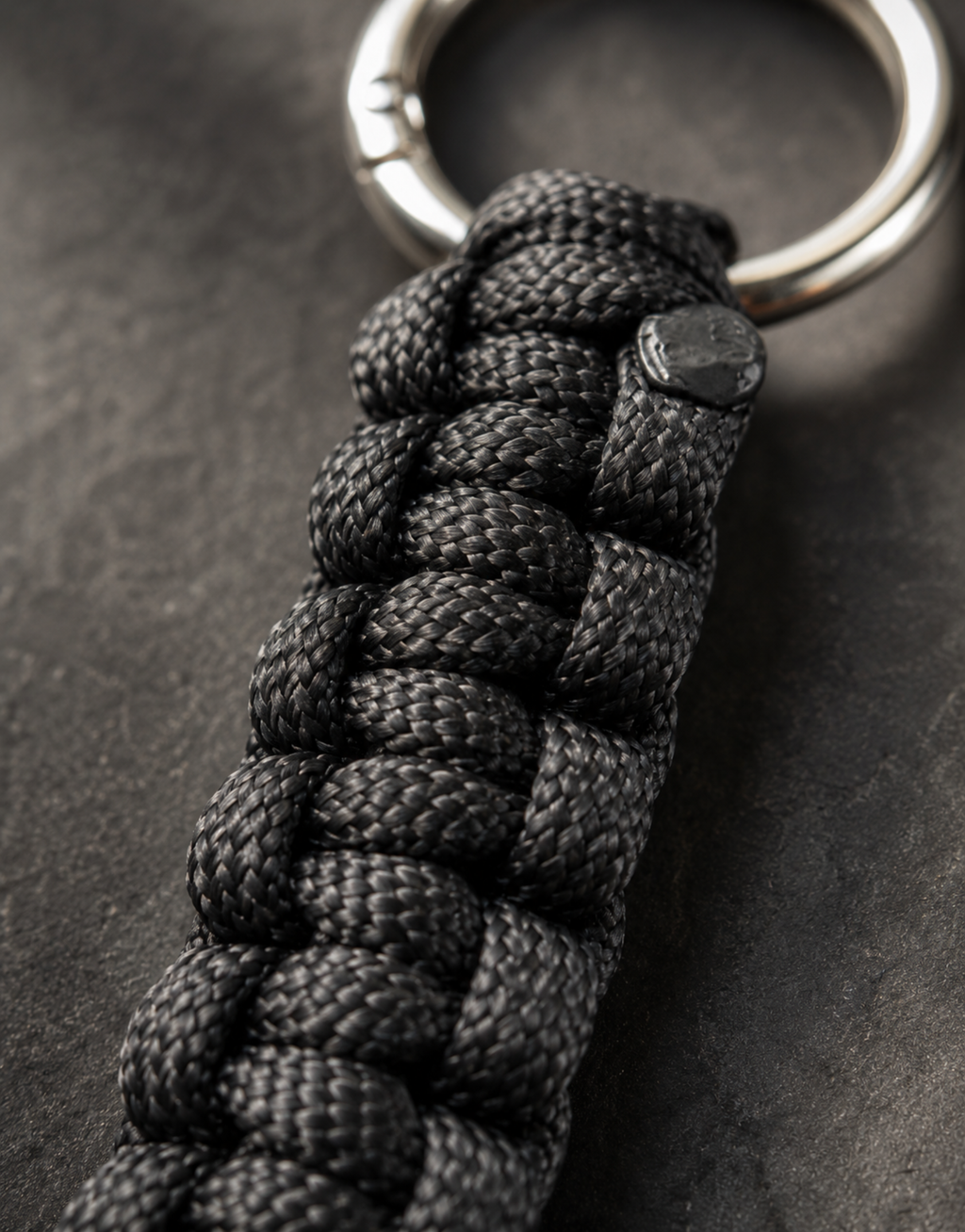 Close-up of the black cobra weave on the Naag paracord keychain