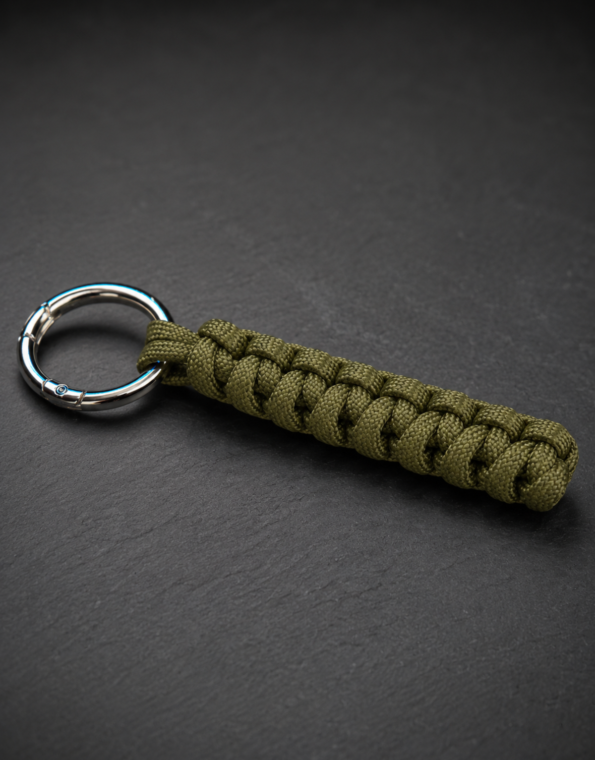Lahar olive spiral paracord keychain lying flat on slate