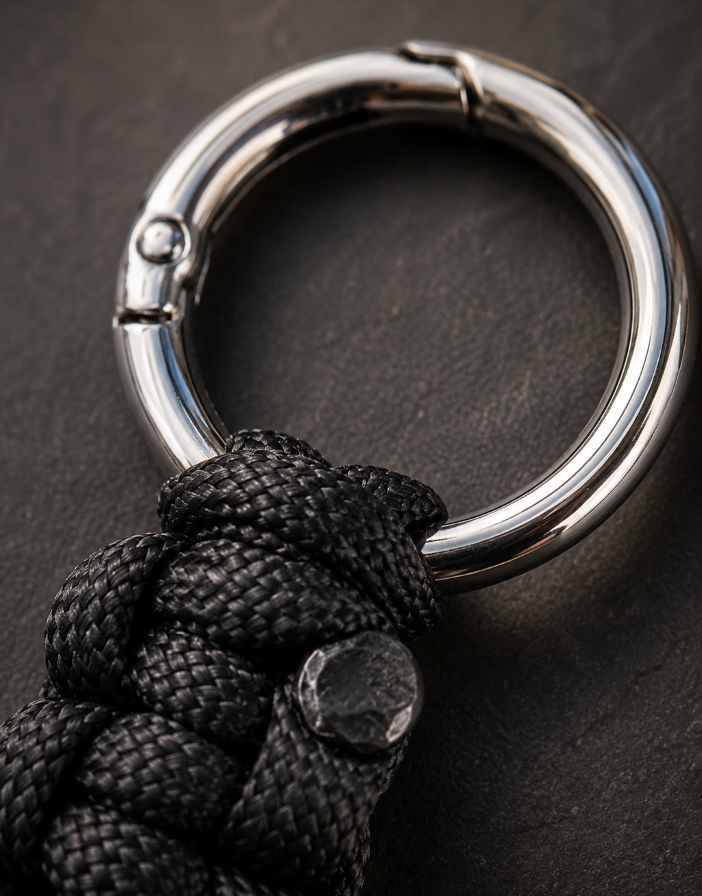 Steel clasp ring on the Naag black paracord keychain