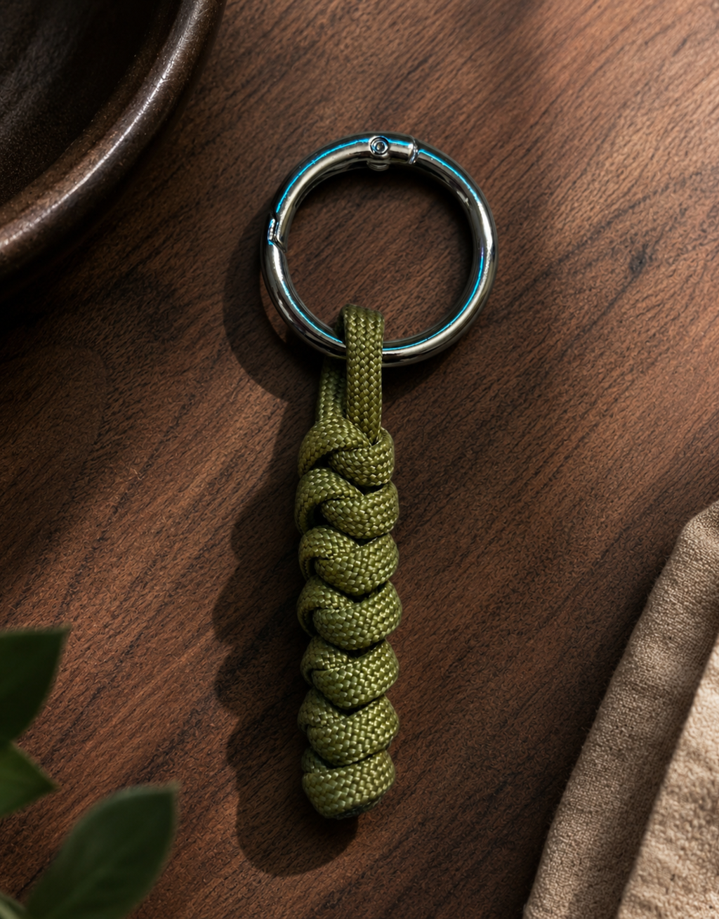 Lahar olive paracord keychain on a wooden table