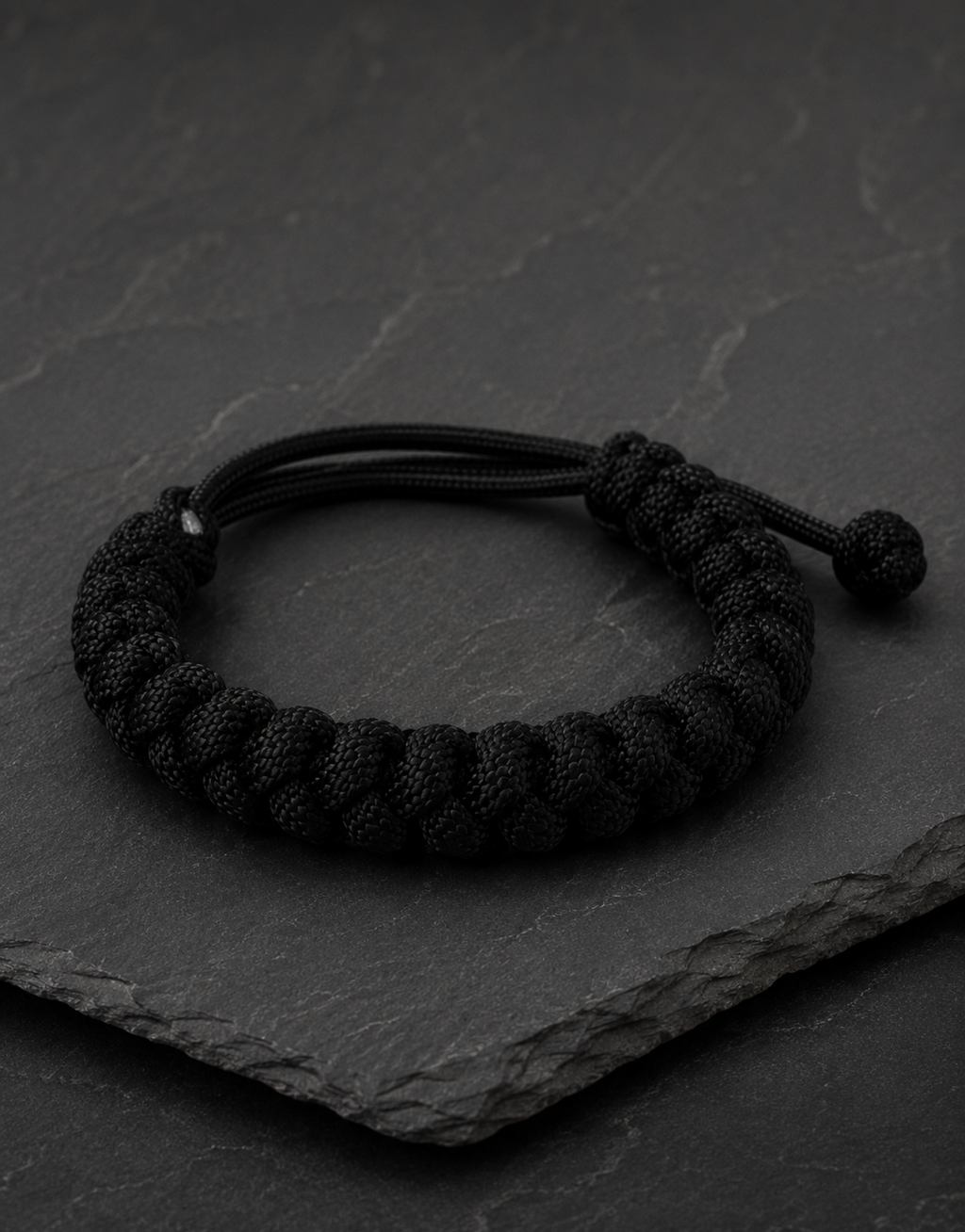 Pech black paracord bracelet on dark slate