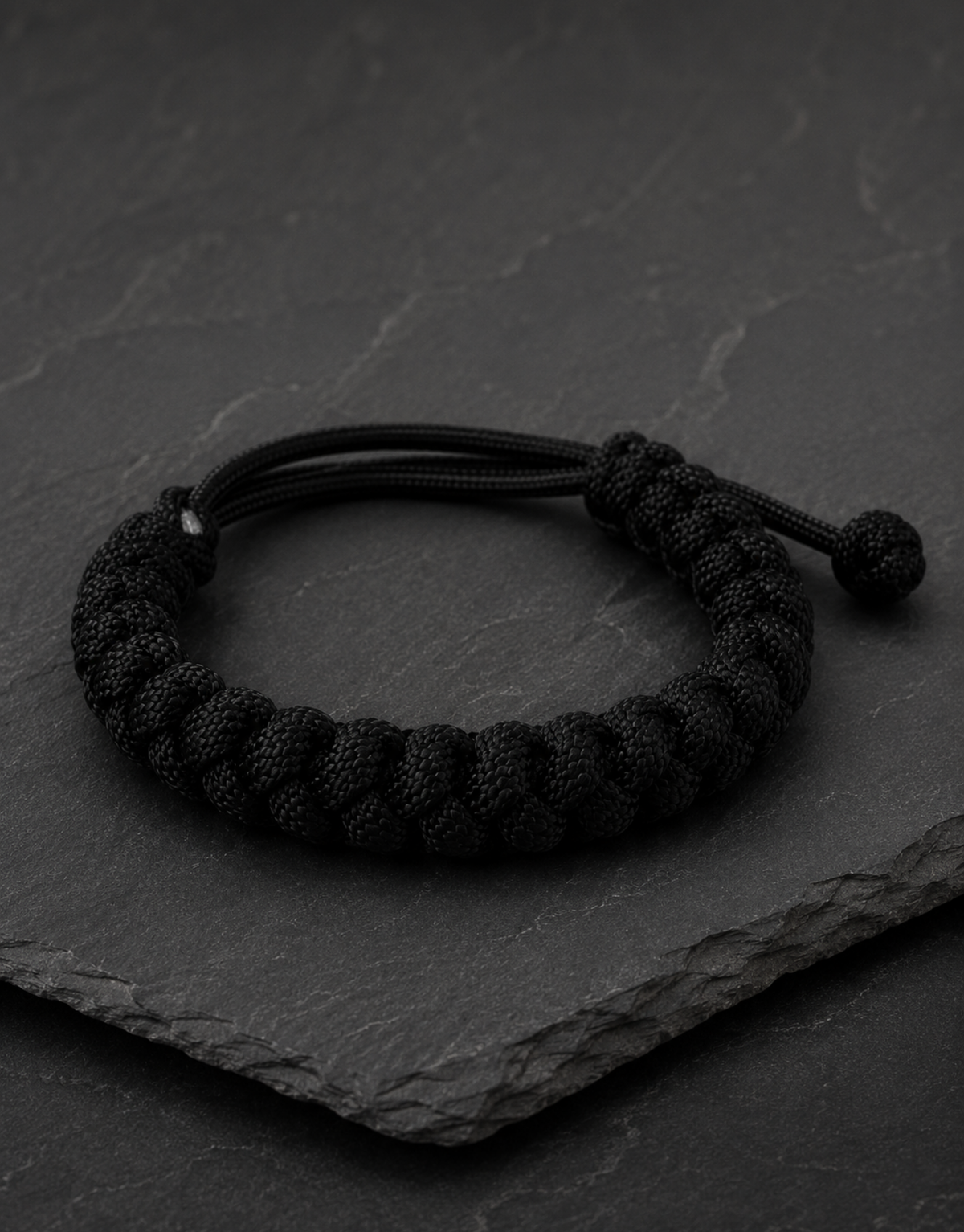 Pech black paracord bracelet on dark slate