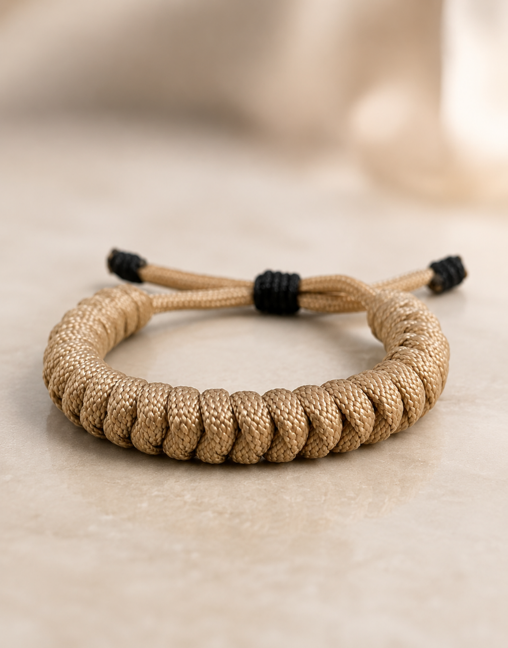 Raml tan paracord bracelet on a stone surface