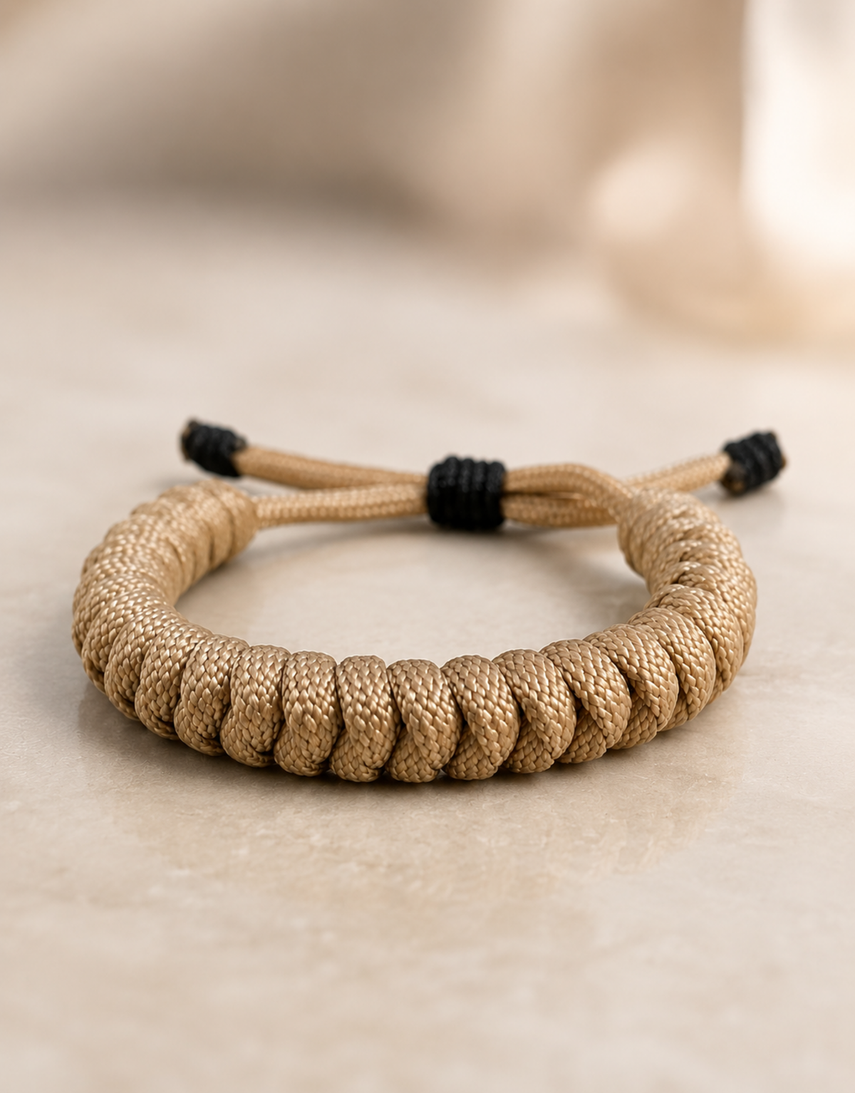 Raml tan paracord bracelet on a stone surface