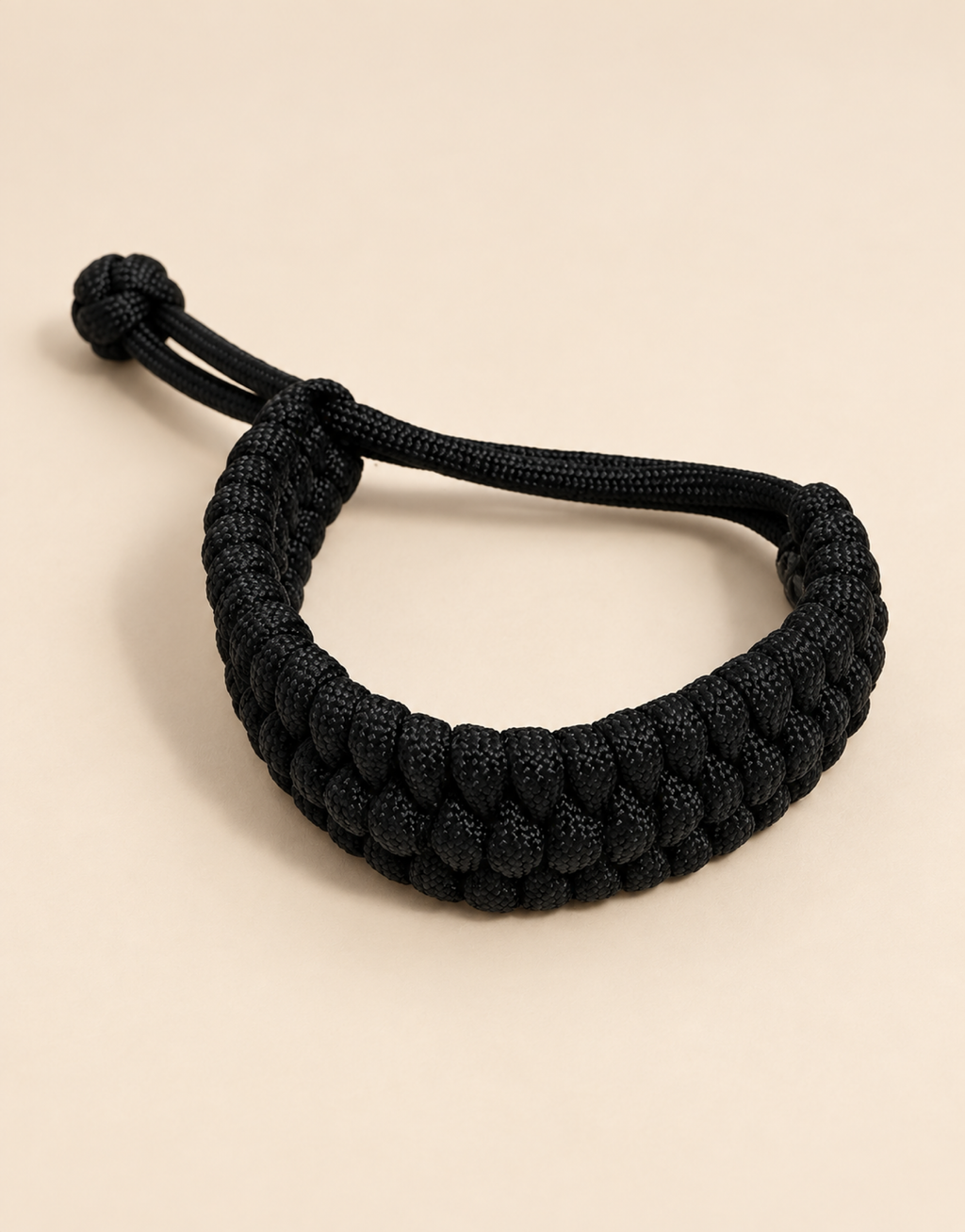 Musallas black paracord bracelet on beige