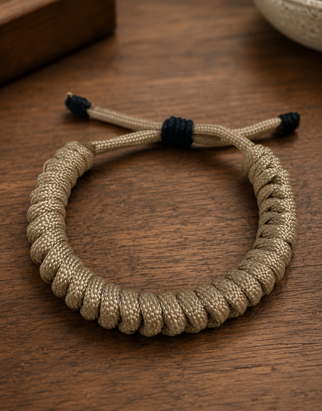 Raml sand spiral paracord bracelet on a wooden table