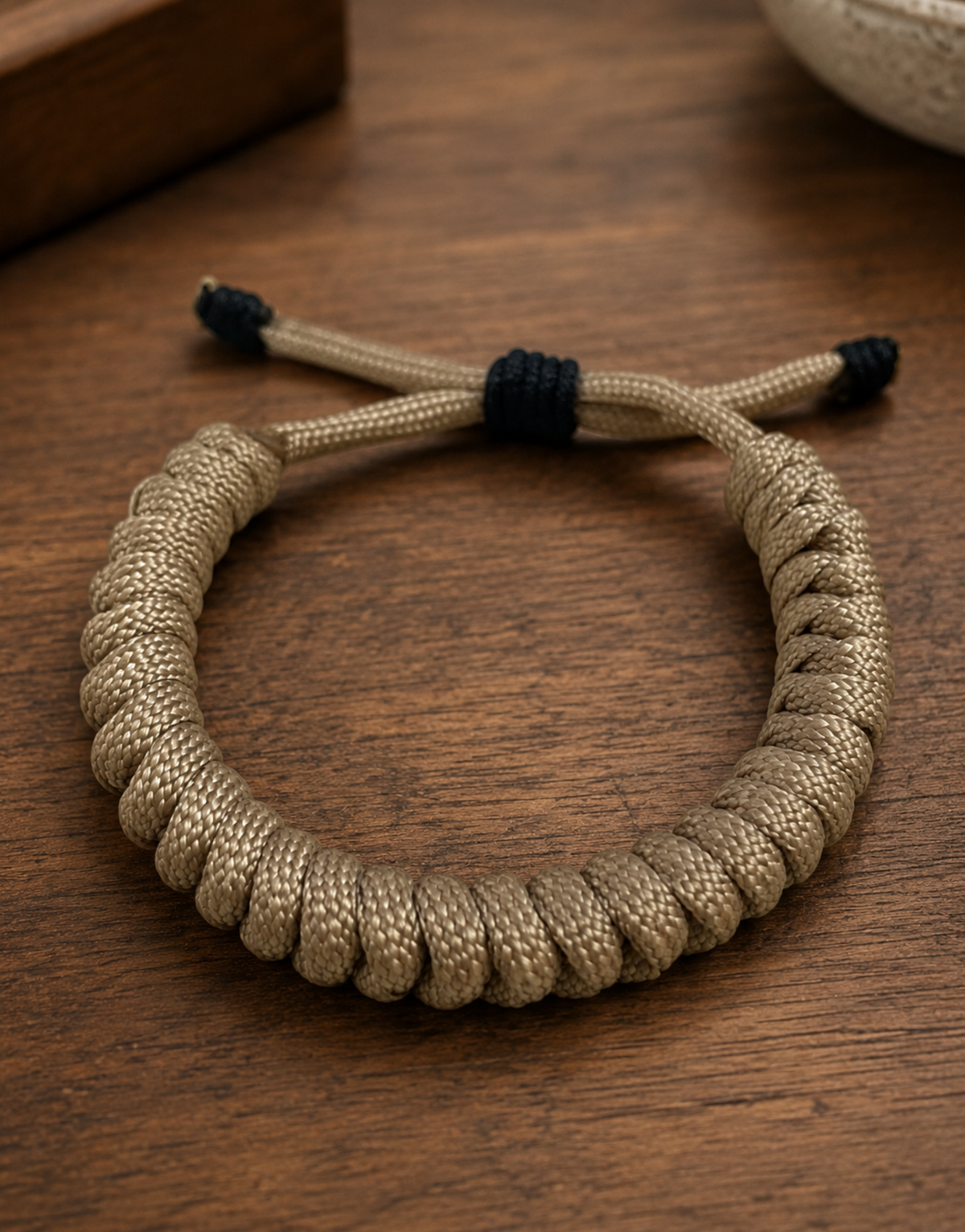 Raml sand spiral paracord bracelet on a wooden table