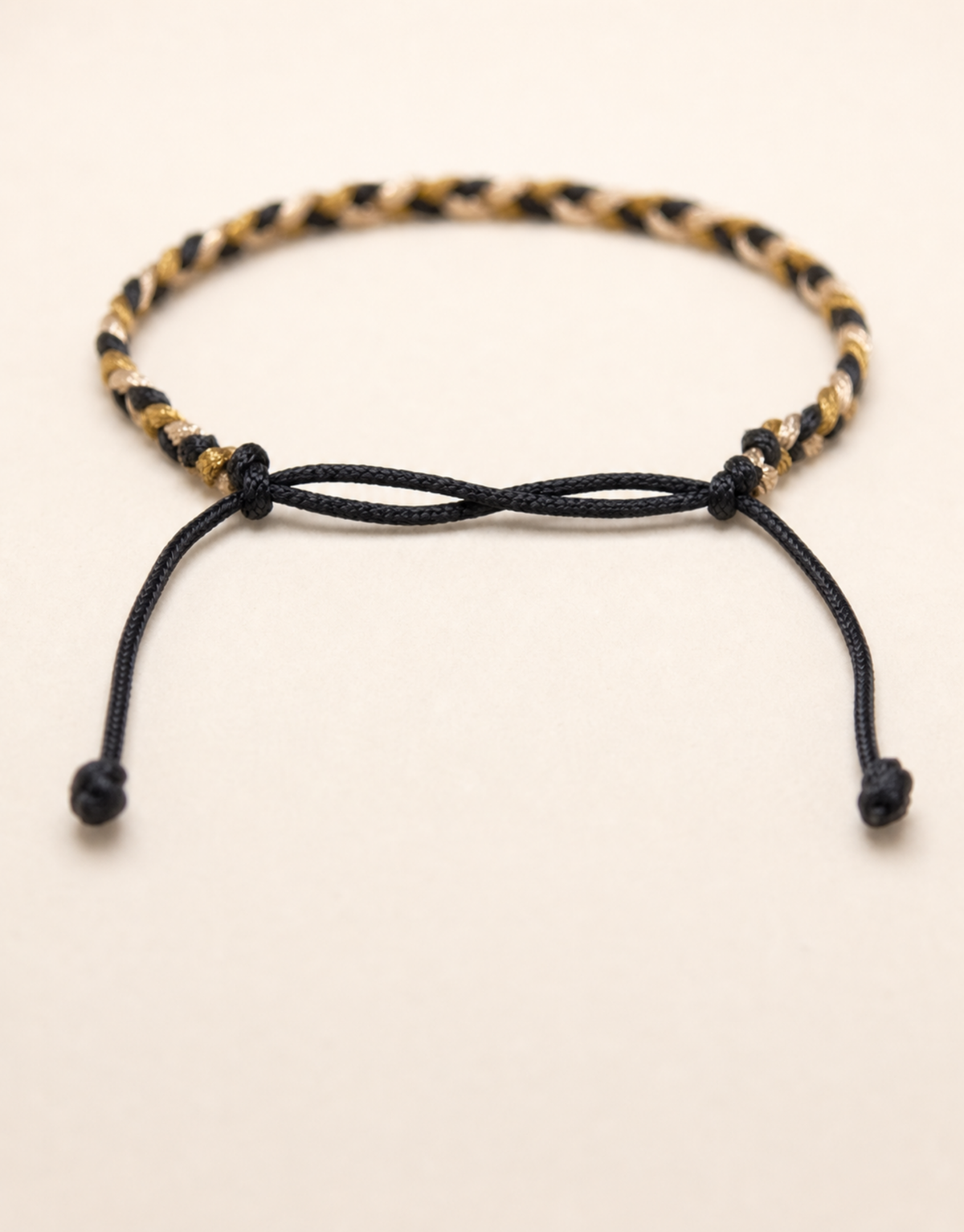 Zari gold macrame bracelet on a cream background