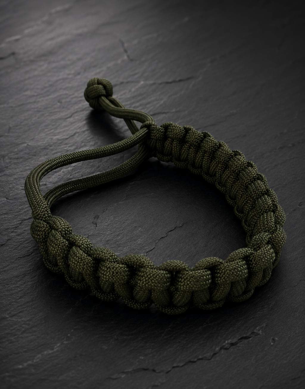 Akhdar dark green paracord bracelet on black slate