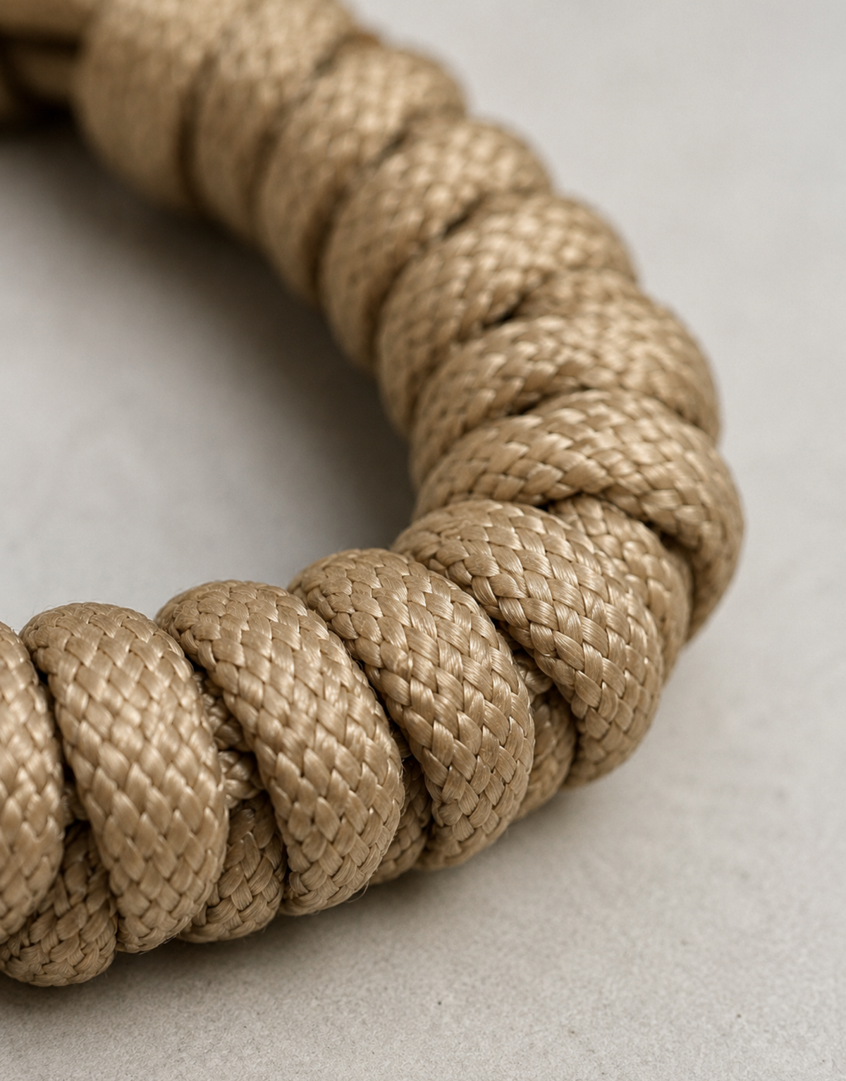 Close-up of the sand colour spiral weave on the Raml paracord bracelet