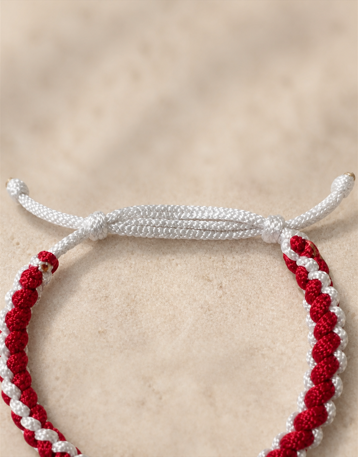 White sliding closure on the Anaar red macrame bracelet
