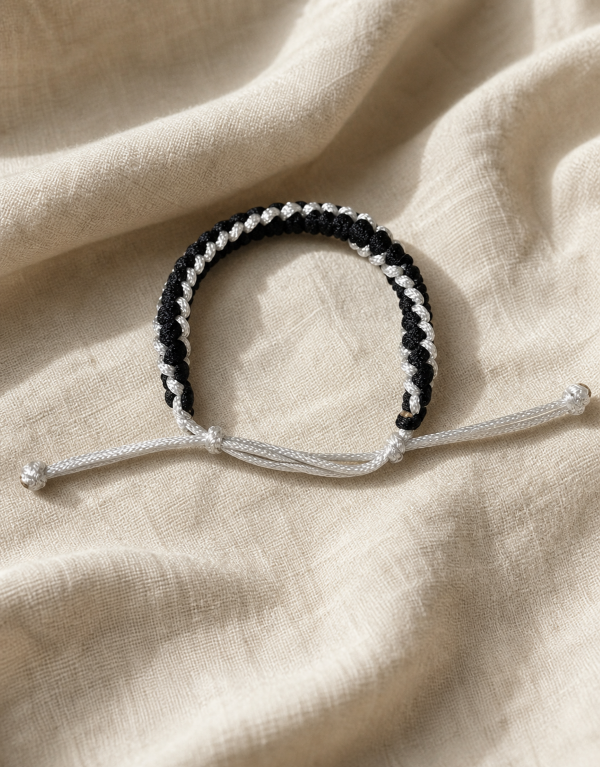 Shatranj black and white macrame bracelet on linen