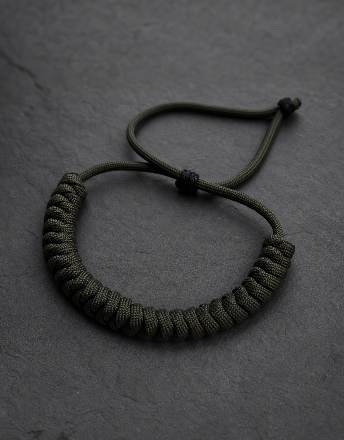 Ghaba green paracord bracelet on grey slate
