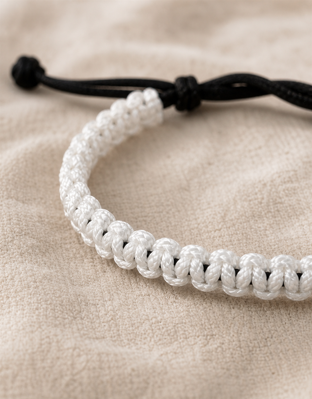 Close-up of the white and black weave on the Qamar macrame bracelet