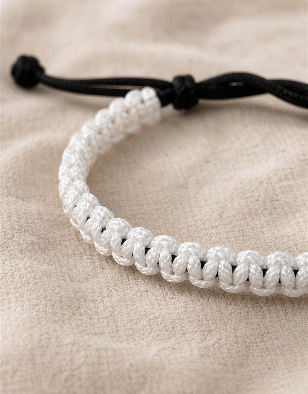 Close-up of the white and black weave on the Qamar macrame bracelet