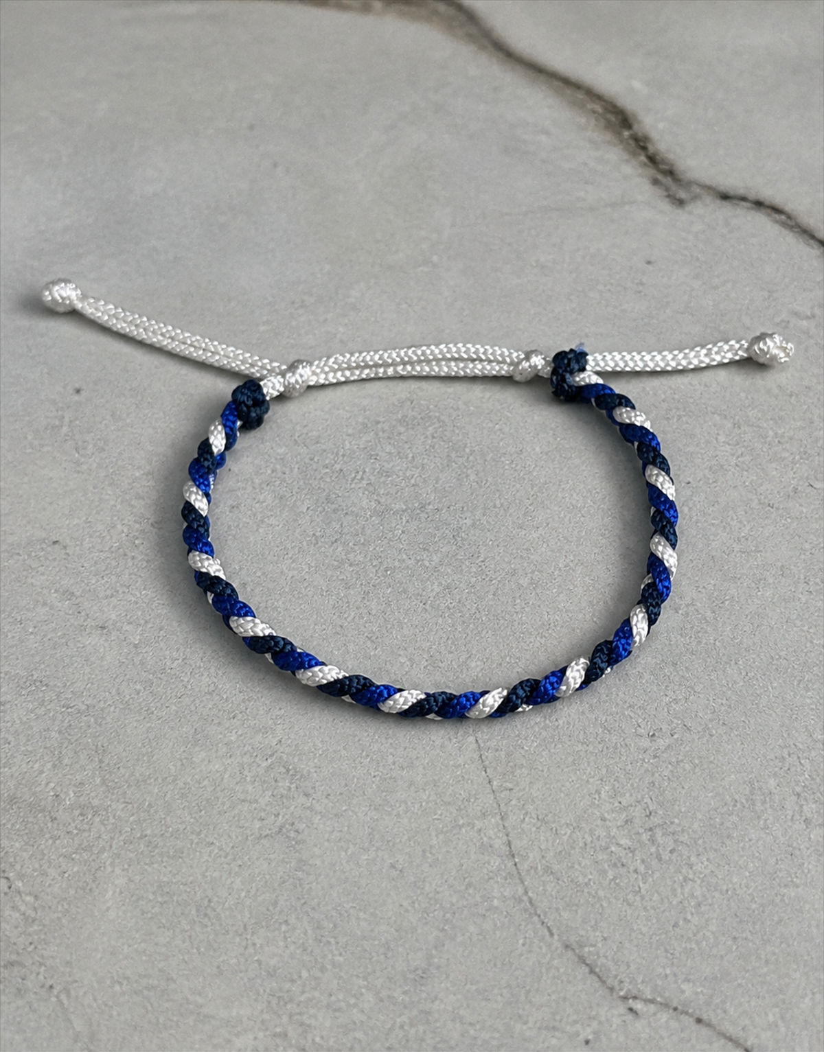 Sadeem twist macrame bracelet on grey concrete