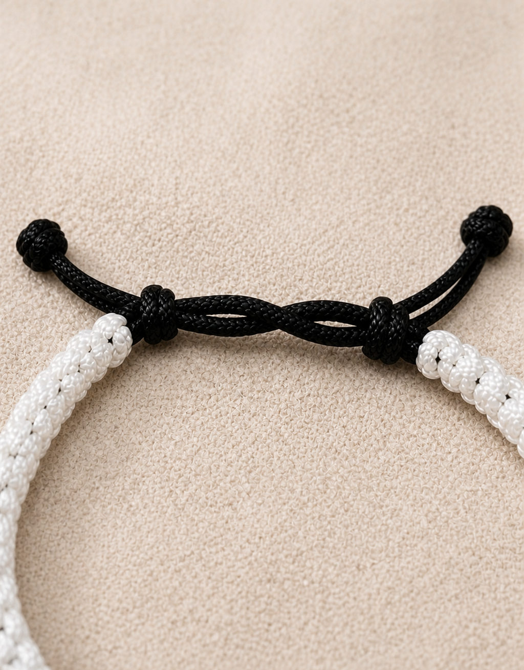 Black sliding knot closure on the Qamar white macrame bracelet