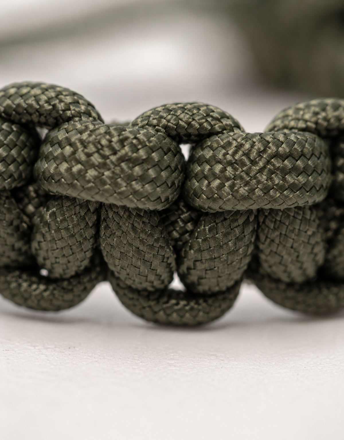 Macro of the dark green cobra weave on the Akhdar paracord bracelet