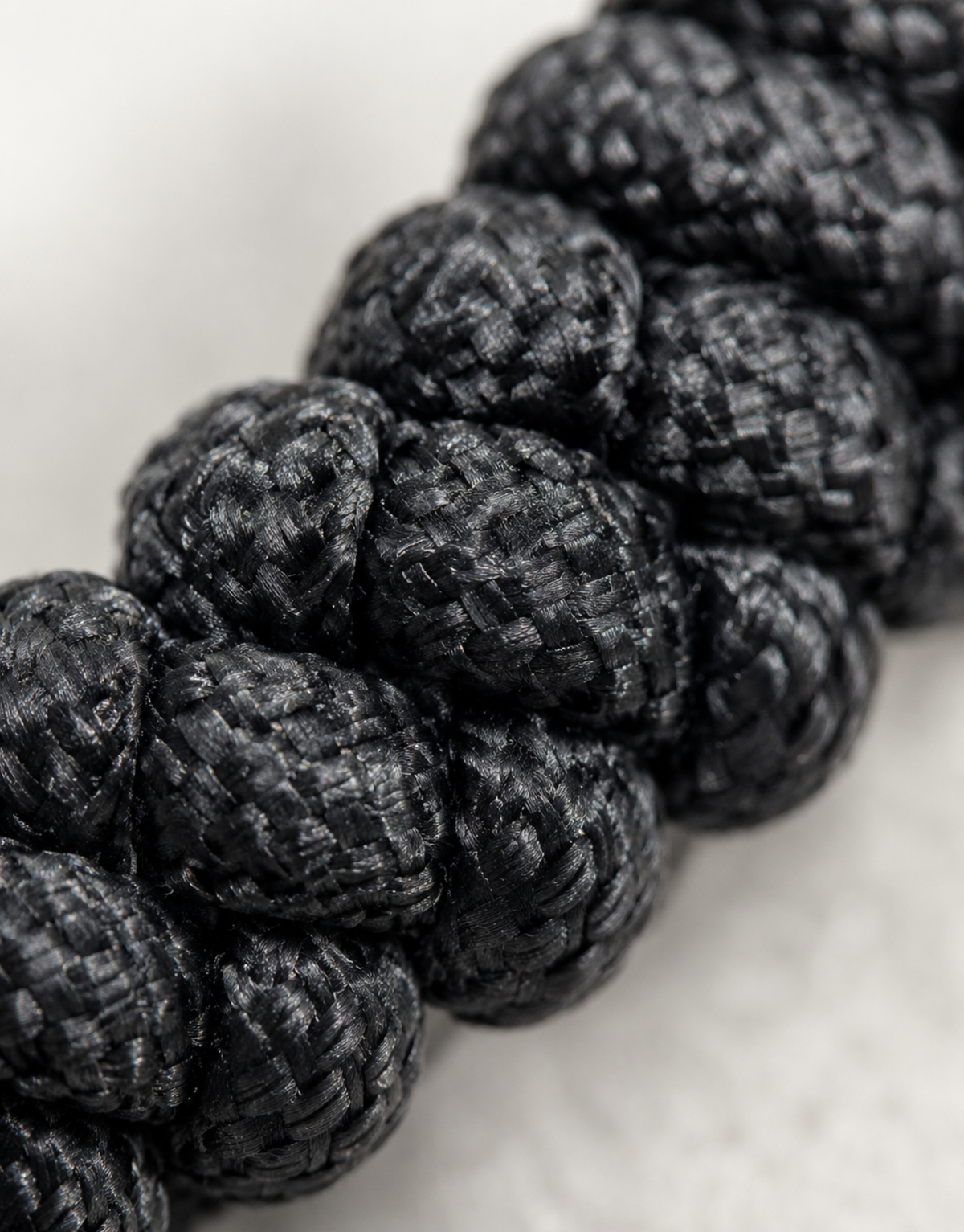 Extreme macro of the Pech black paracord spiral knot