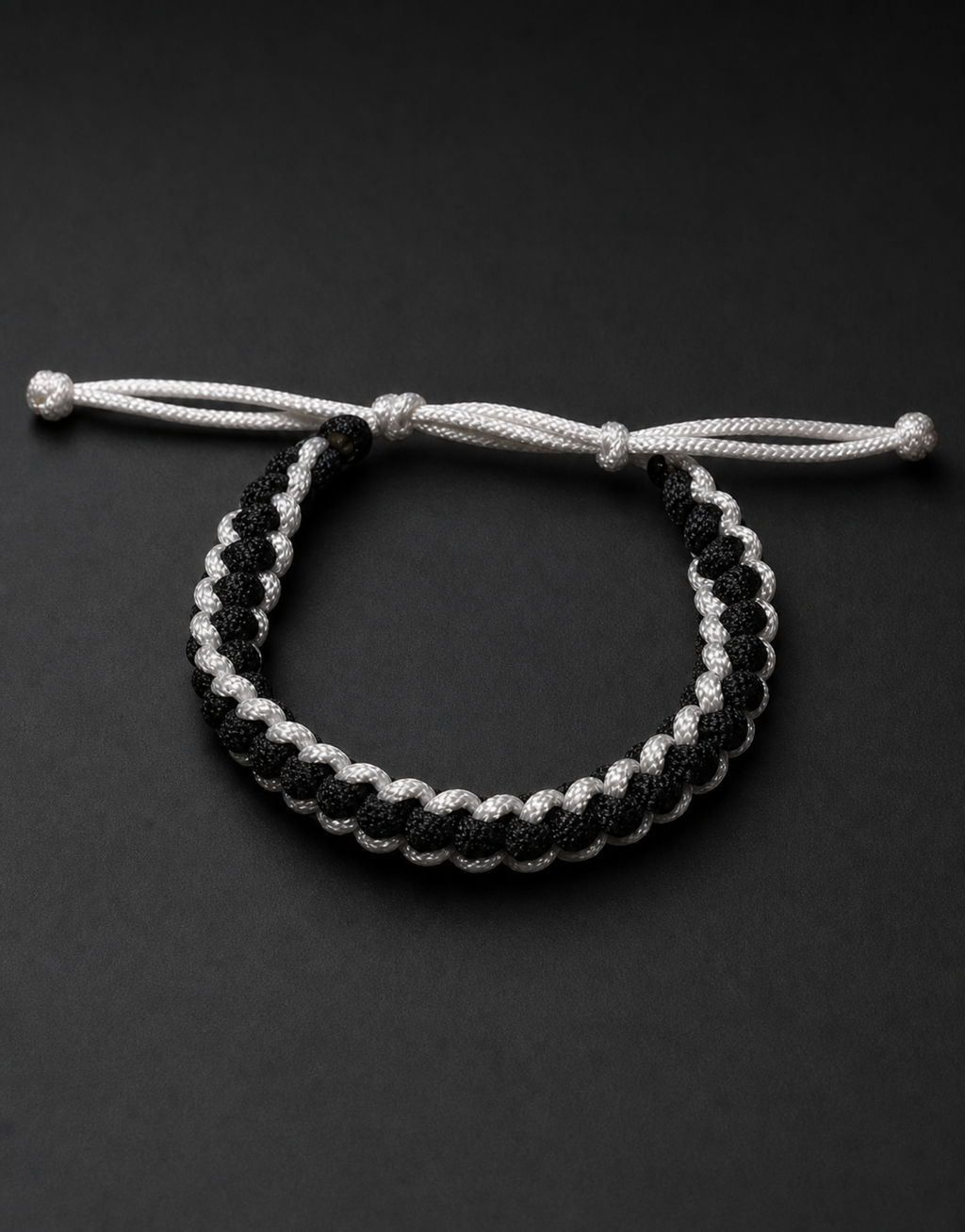 Shatranj black and white macrame bracelet on a black background