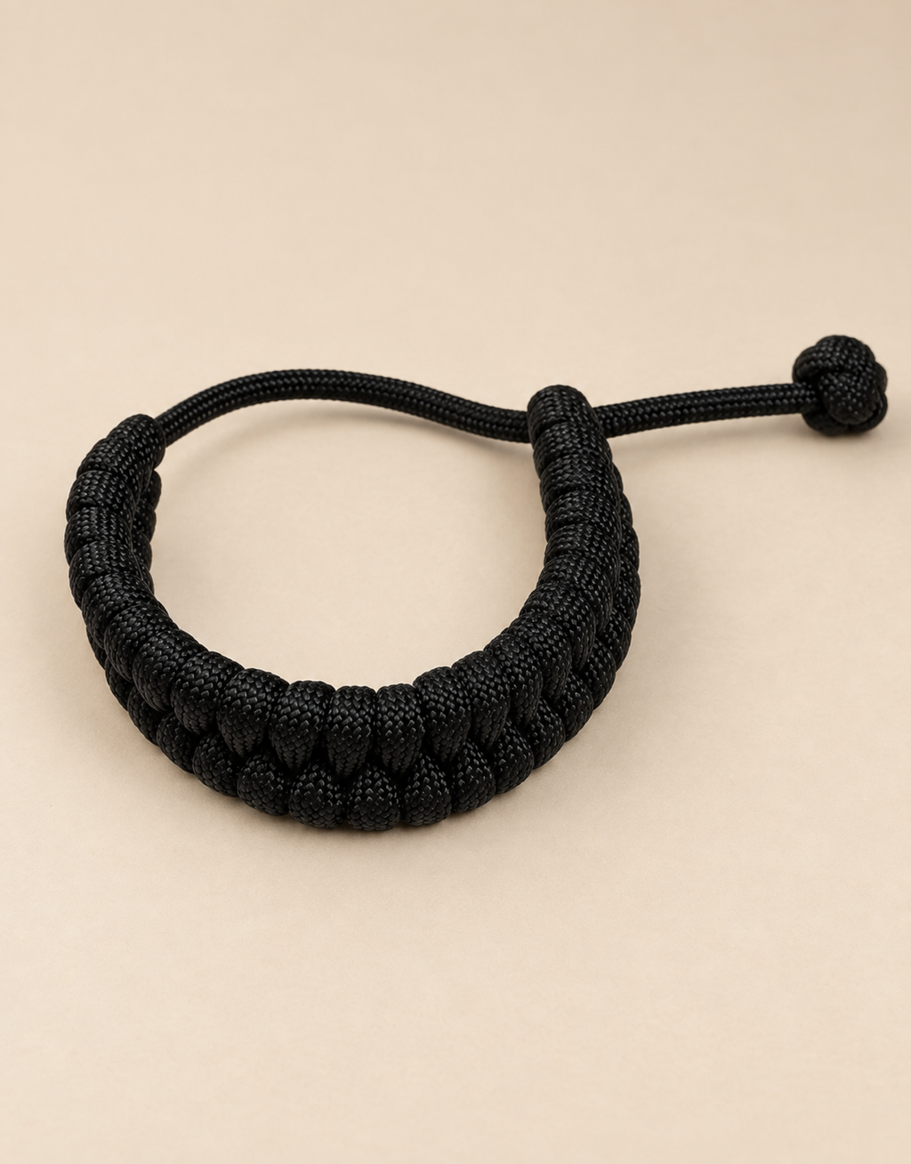 Juft black paracord bracelet on beige