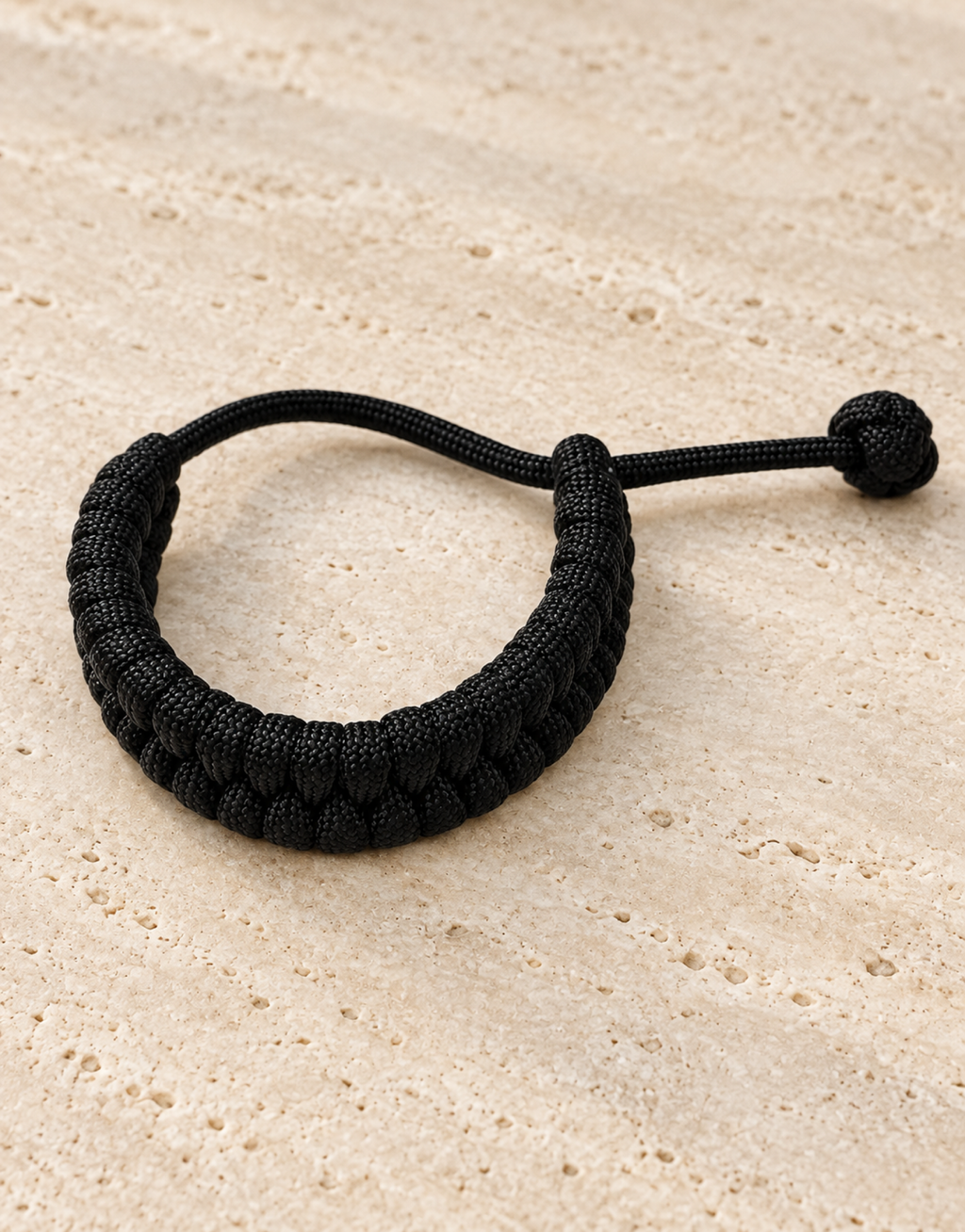 Juft black paracord bracelet on stone