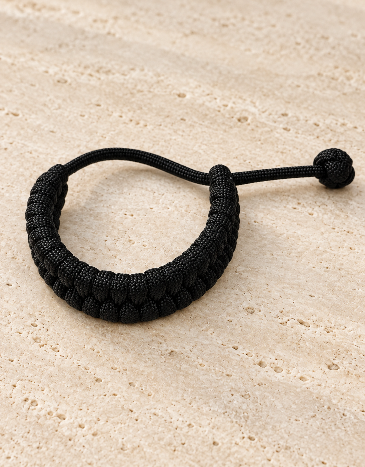 Juft black paracord bracelet on stone