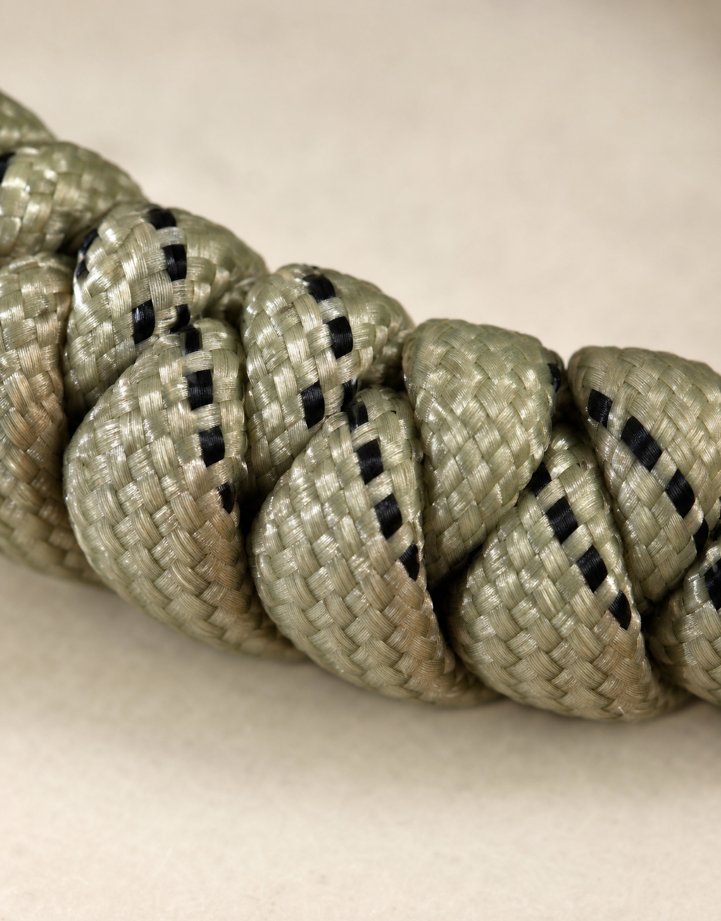 Macro of the speckled sand and black paracord on the Ramad bracelet