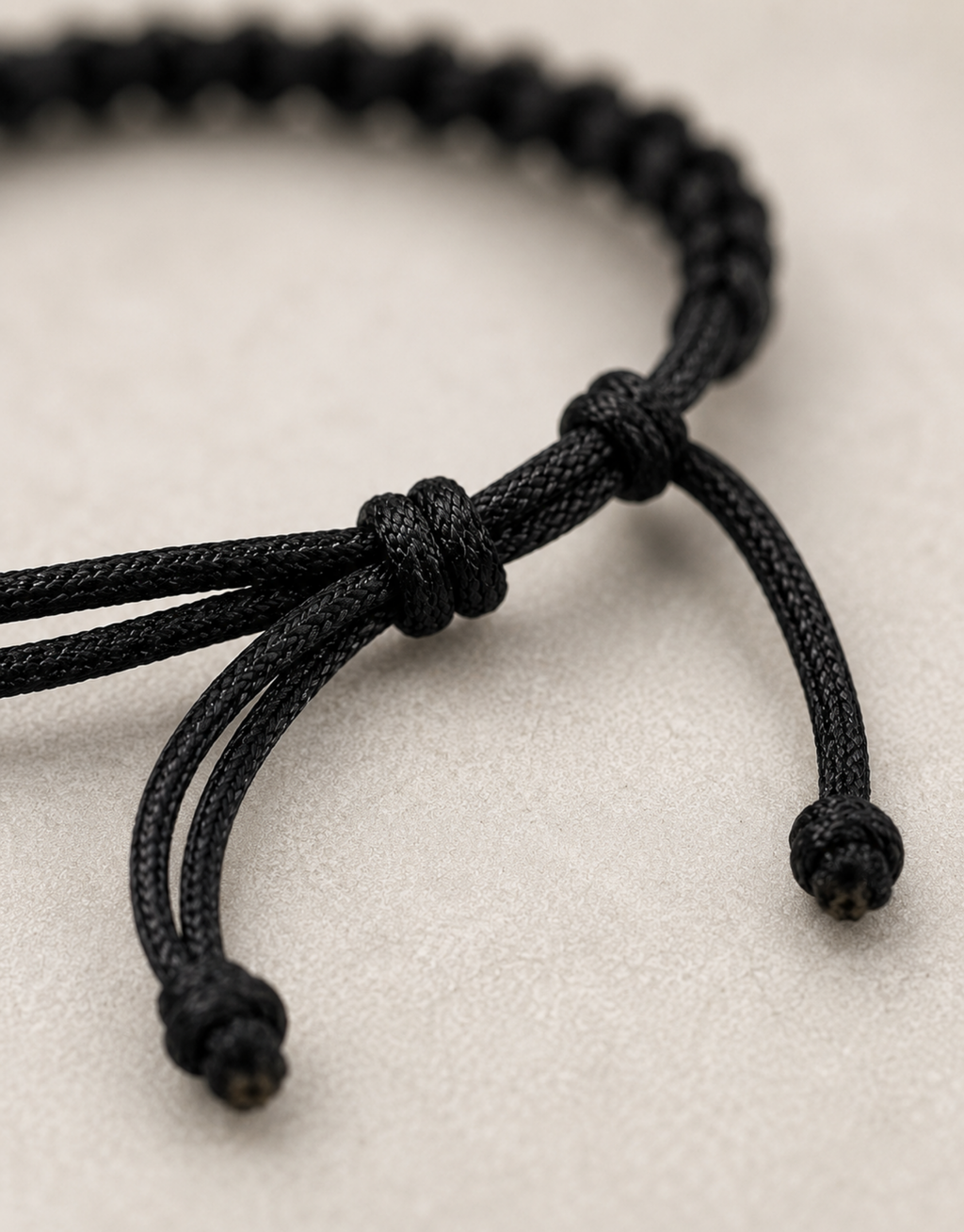 Adjustable sliding knot on the Khayt black macrame bracelet
