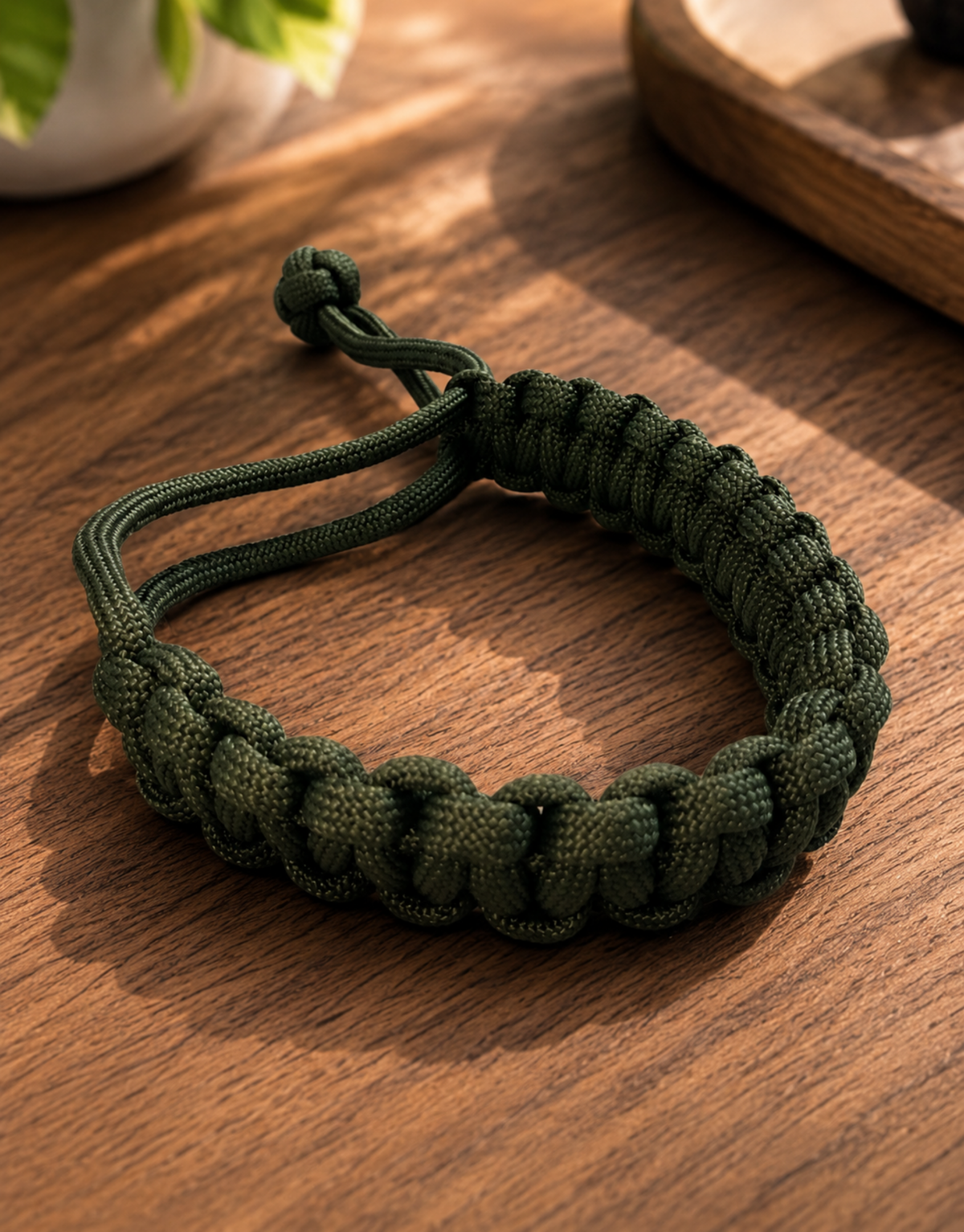 Akhdar army green paracord bracelet on a wooden table