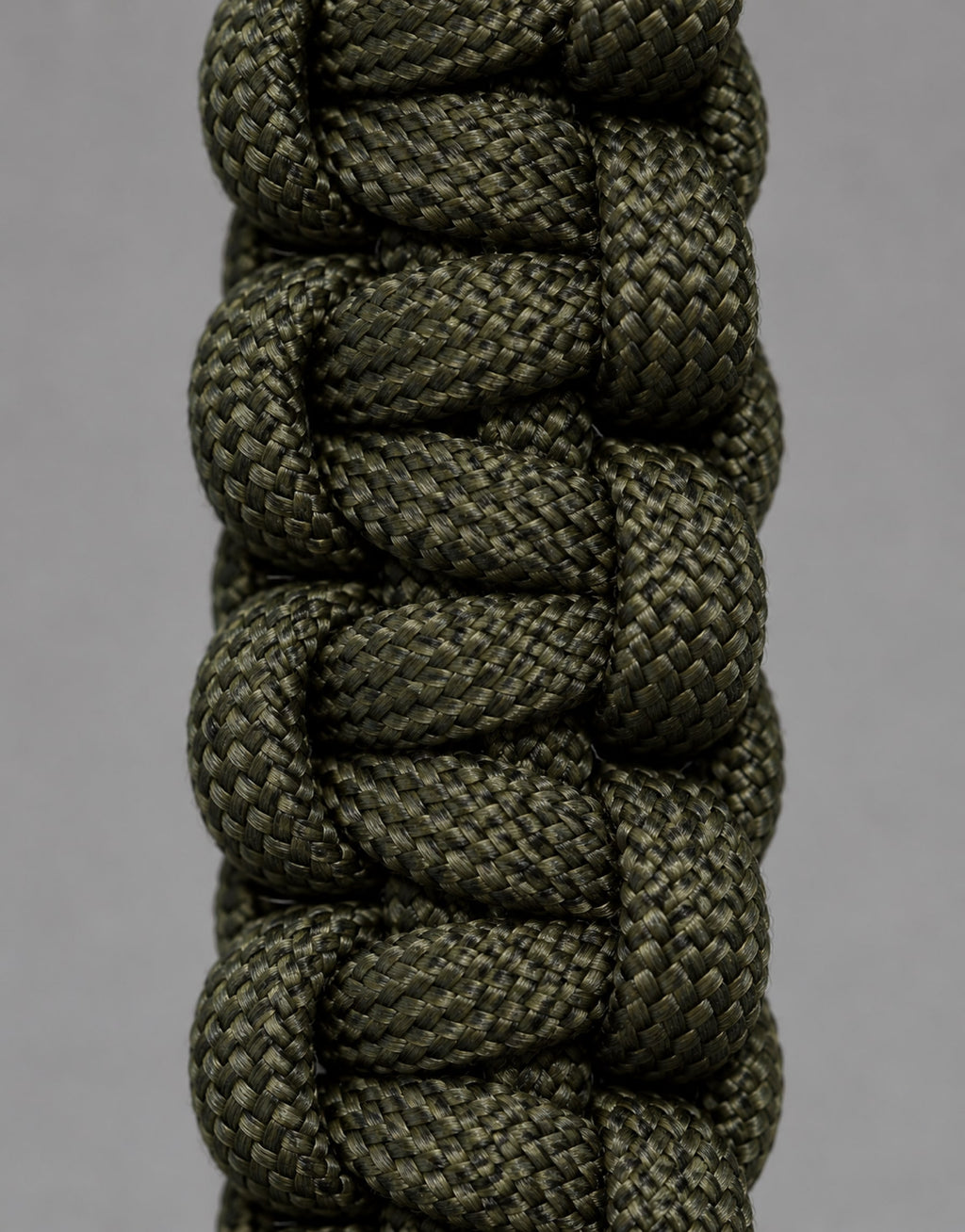 Close-up of the dark green cobra weave on the Naag paracord keychain
